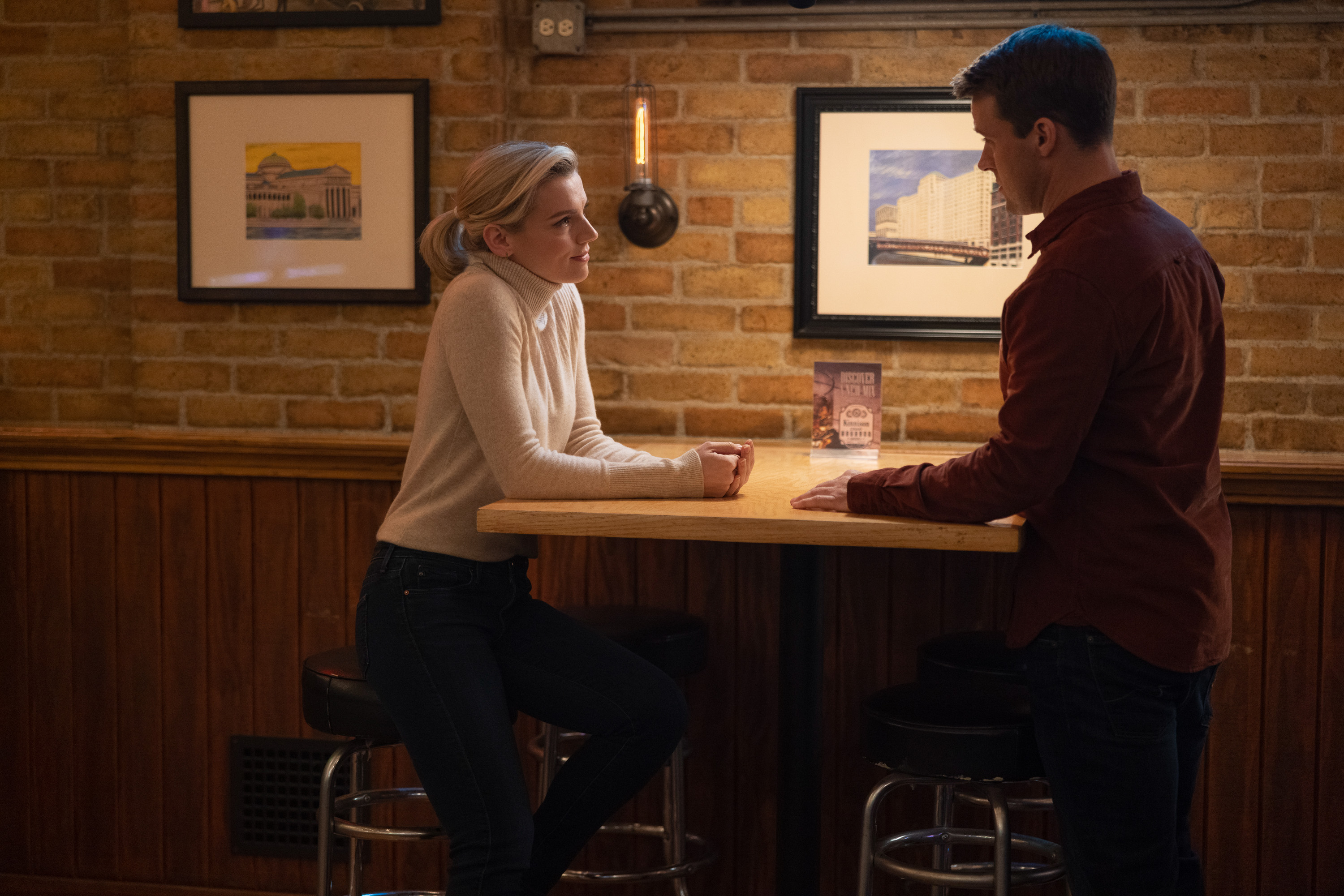 Kara Killmer and Jesse Spencer talk at Molly's bar during a scene from 'Chicago Fire'