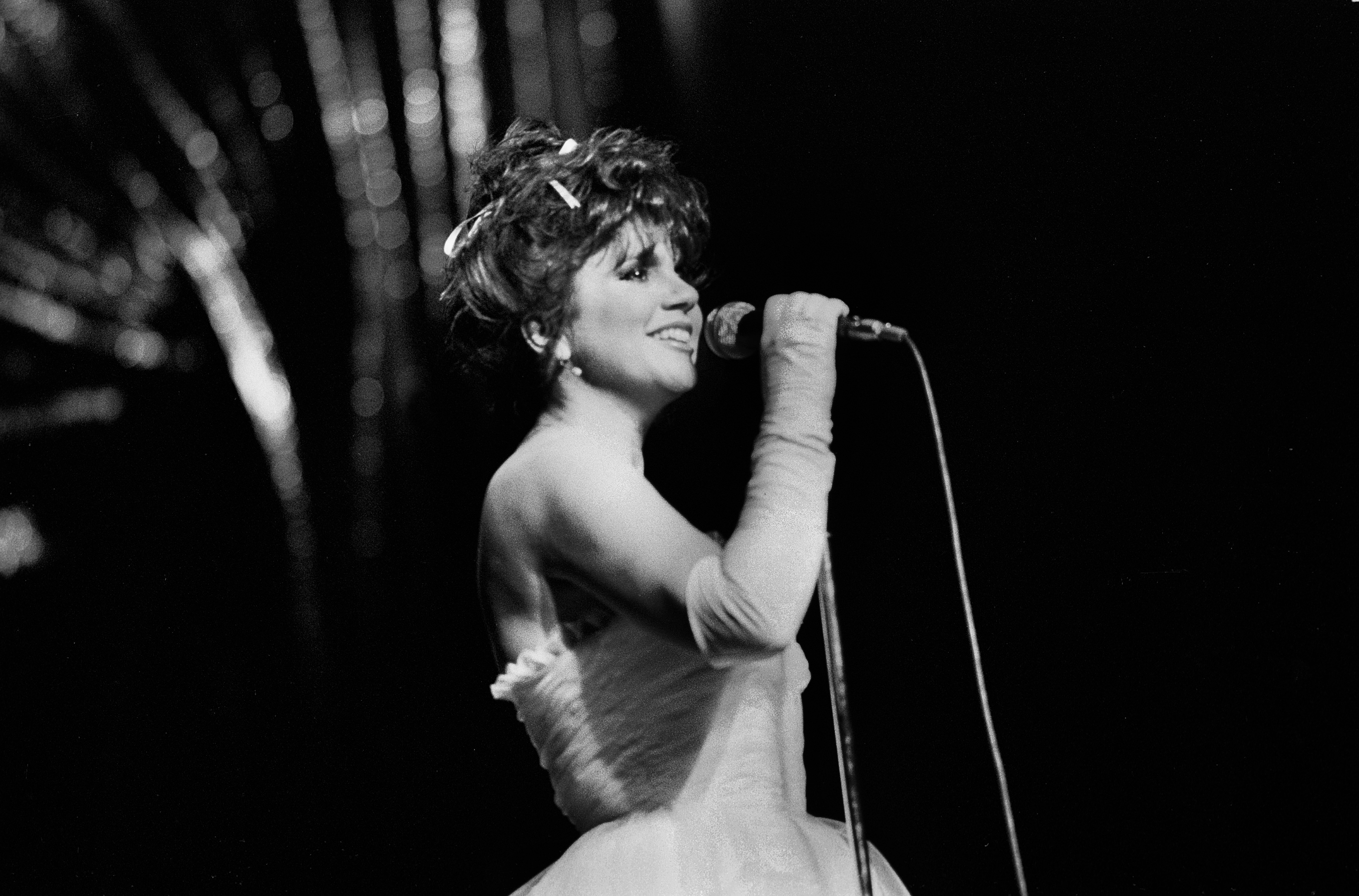 Linda Ronstadt wearing a dress and gloves