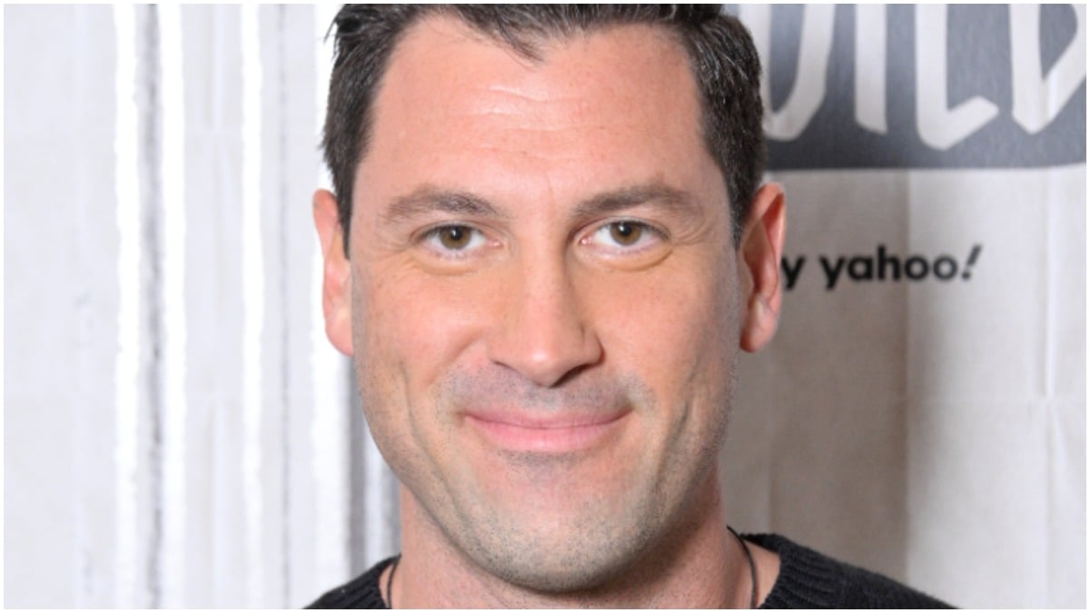 Maksim Chmerkovskiy smiles for the camera on the red carpet.