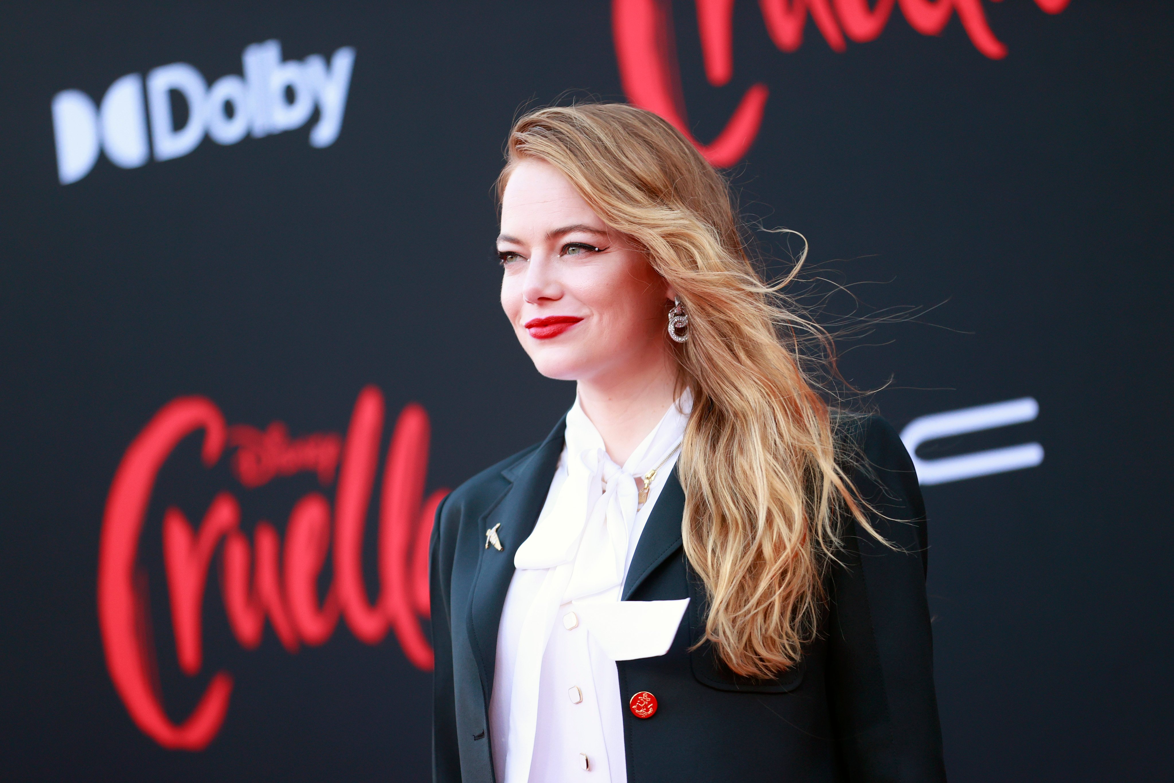 mma Stone smiling at the Los Angeles premiere of Disney's 'Cruella'