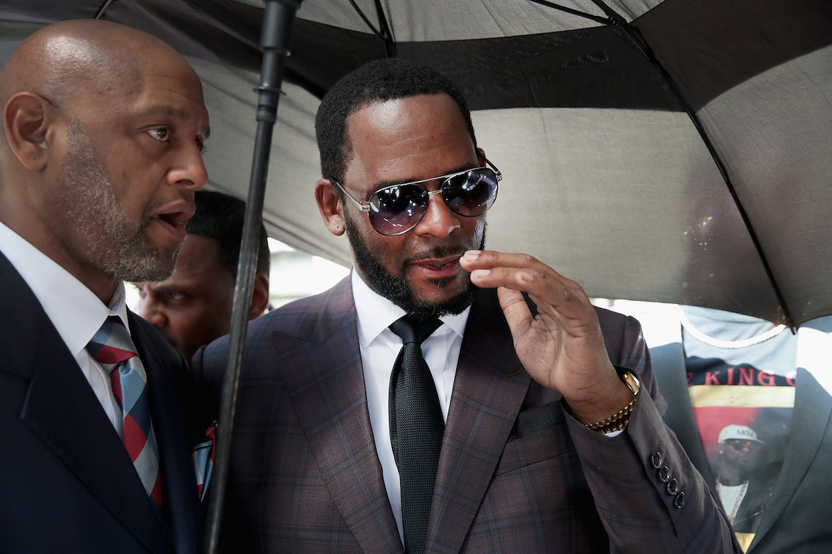 R. Kelly (R) leaves the Leighton Criminal Courts Building following a hearing on June 26, 2019 in Chicago, Illinois. Prosecutors turned over to Kelly's defense team a DVD that alleges to show Kelly having sex with an underage girl in the 1990s. Kelly has been charged with multiple sex crimes involving four women, three of whom were underage at the time of the alleged encounters.
