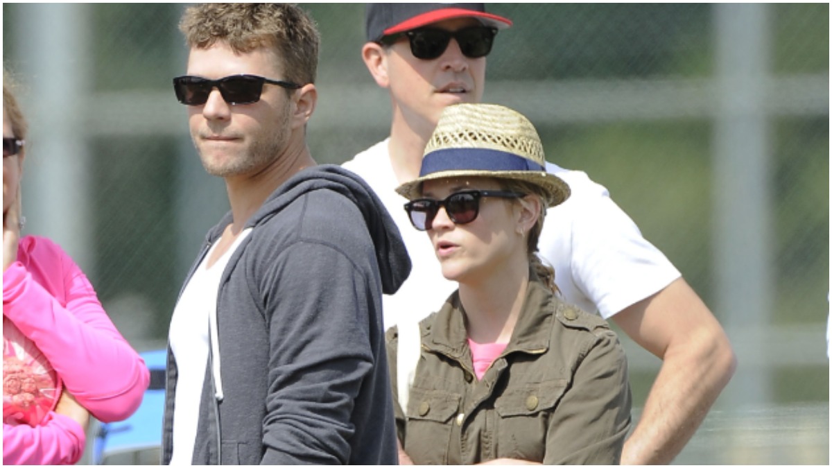 Ryan Phillippe and Reese Witherspoon attend a football game.