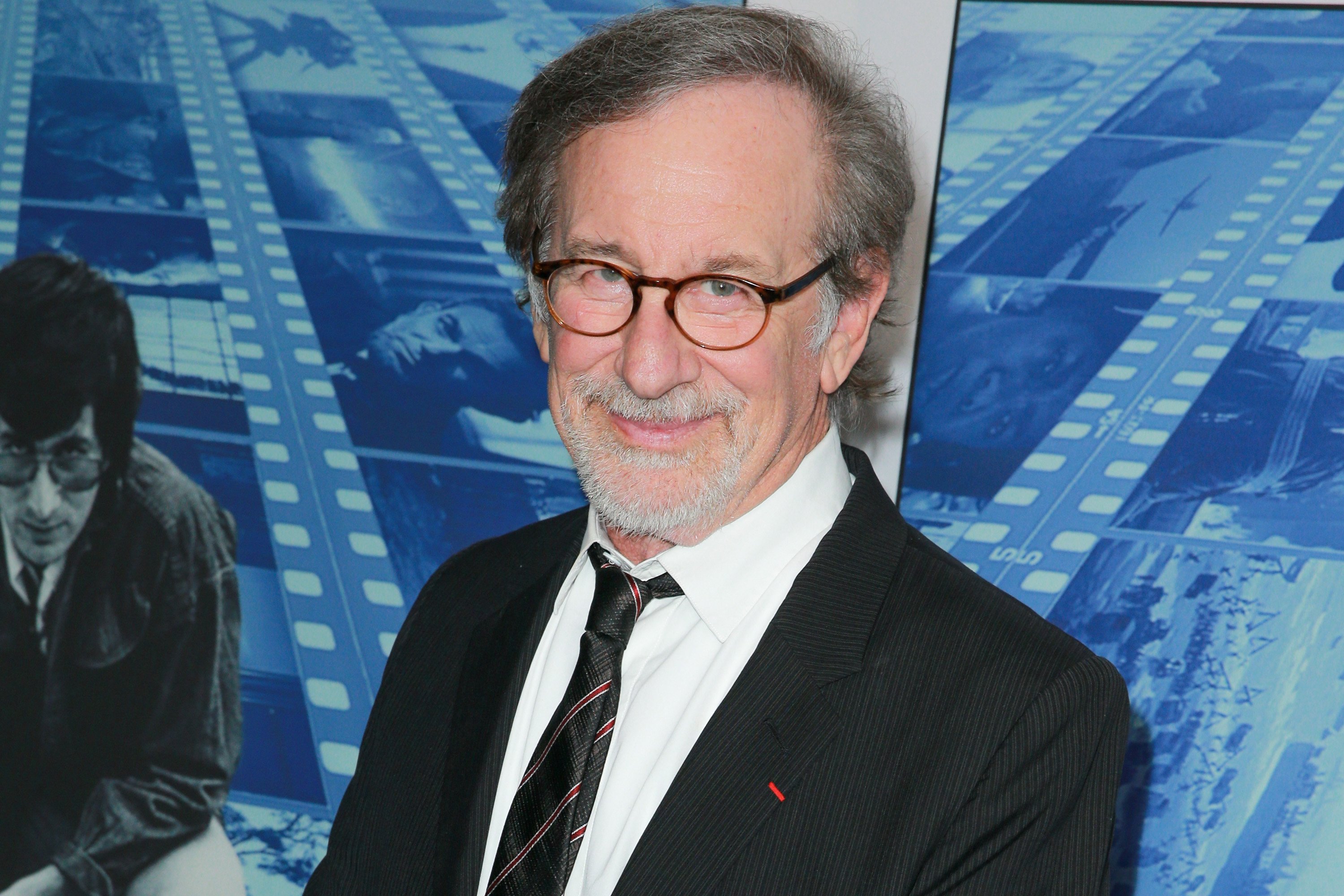 Steven Spielberg wearing a black suit and tie