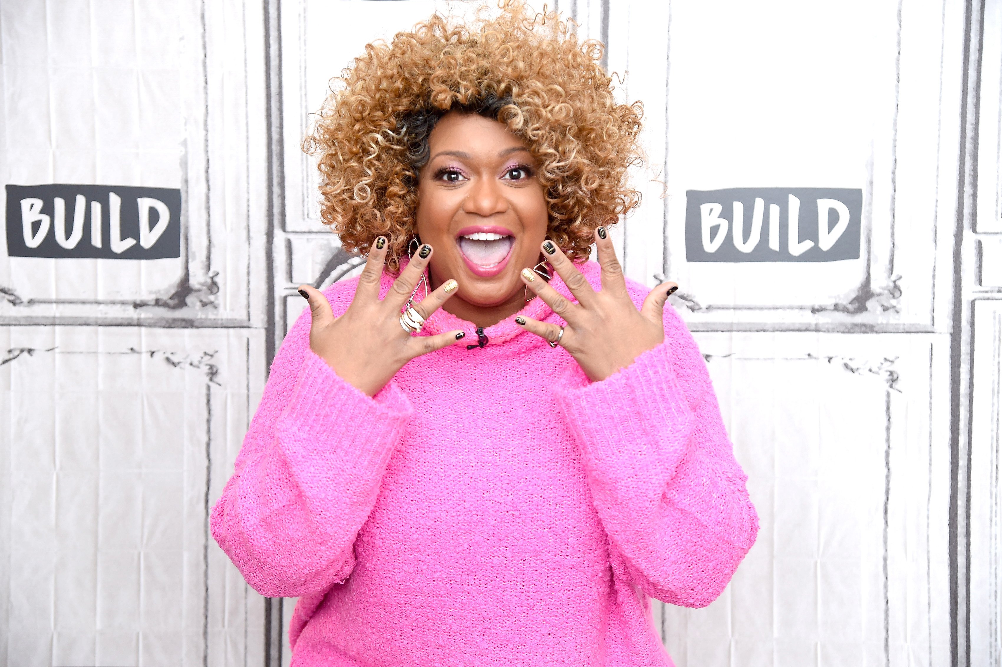 Sunny Anderson excited and showing off her finger nails and rings