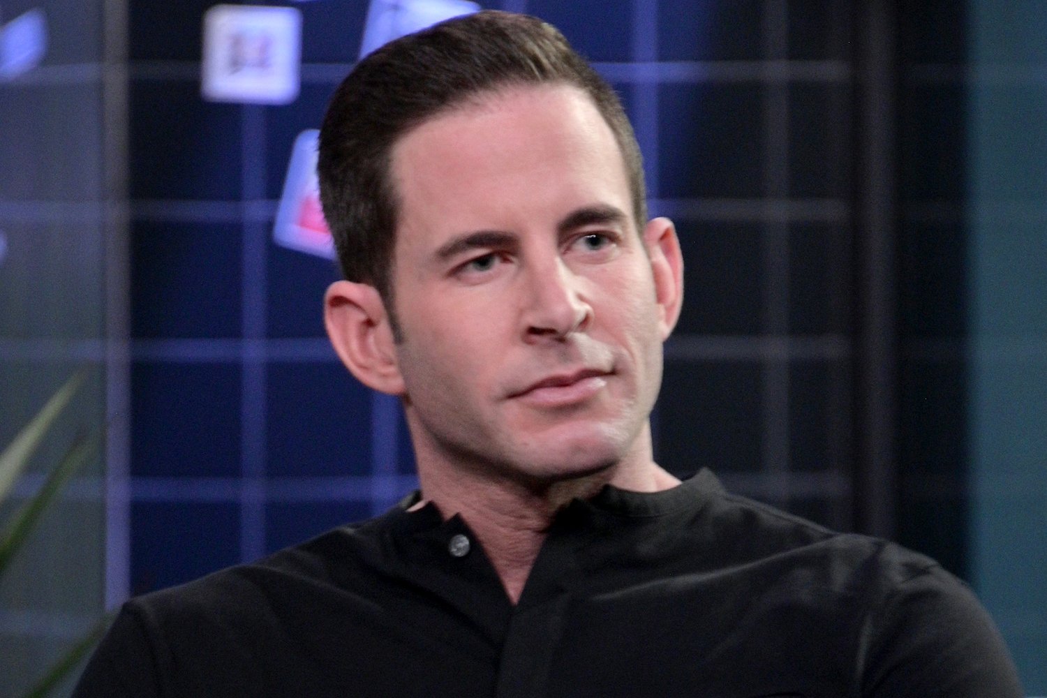 Tarek El Moussa looking serious during an interview