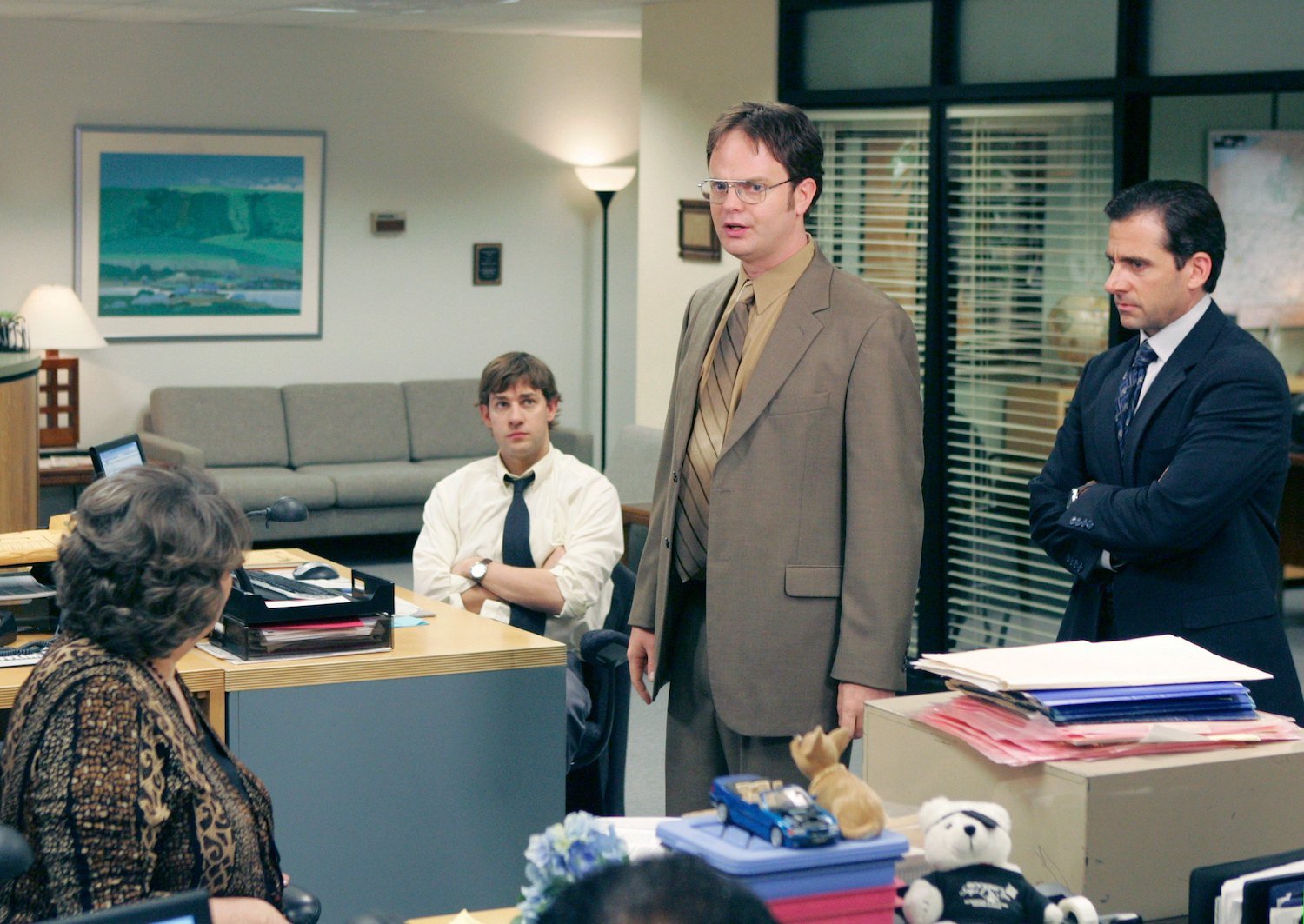 'The Office' stars in character on set. Phyllis Smith as Phyllis Lapin, John Krasinski as Jim Halpert, Rainn Wilson as Dwight Schrute, and Steve Carell as Michael Scott.