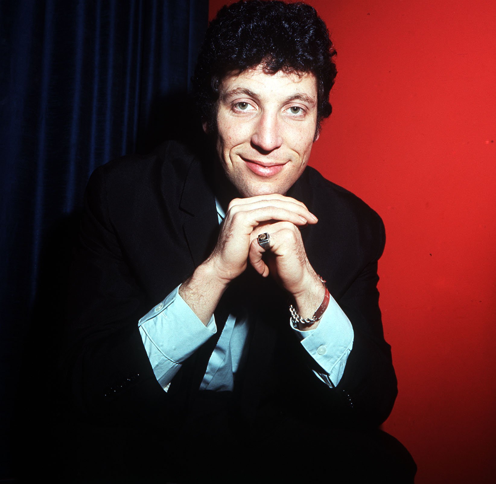 Tom Jones with a red background