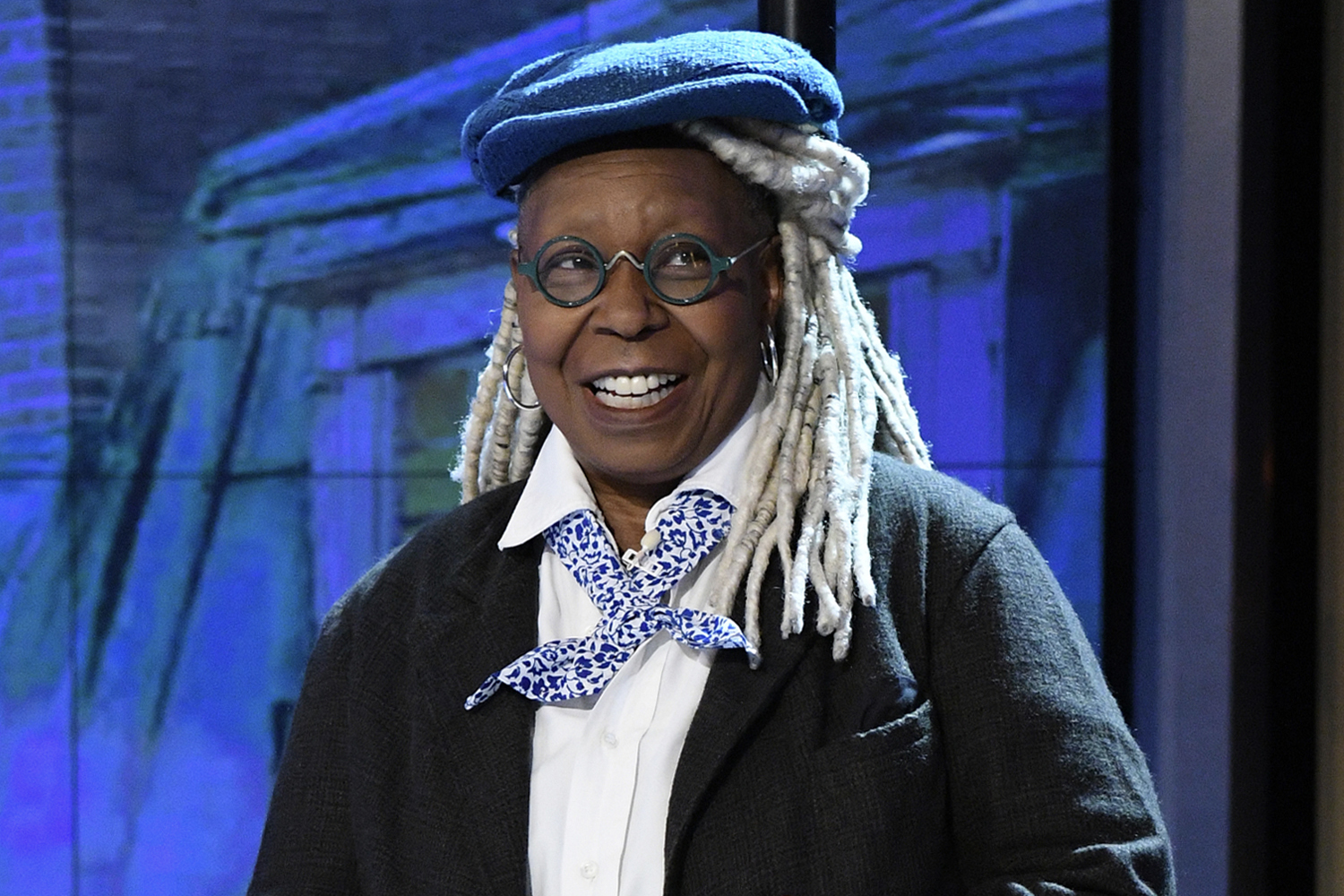 Whoopi Goldberg smiling and wearing a blue beret