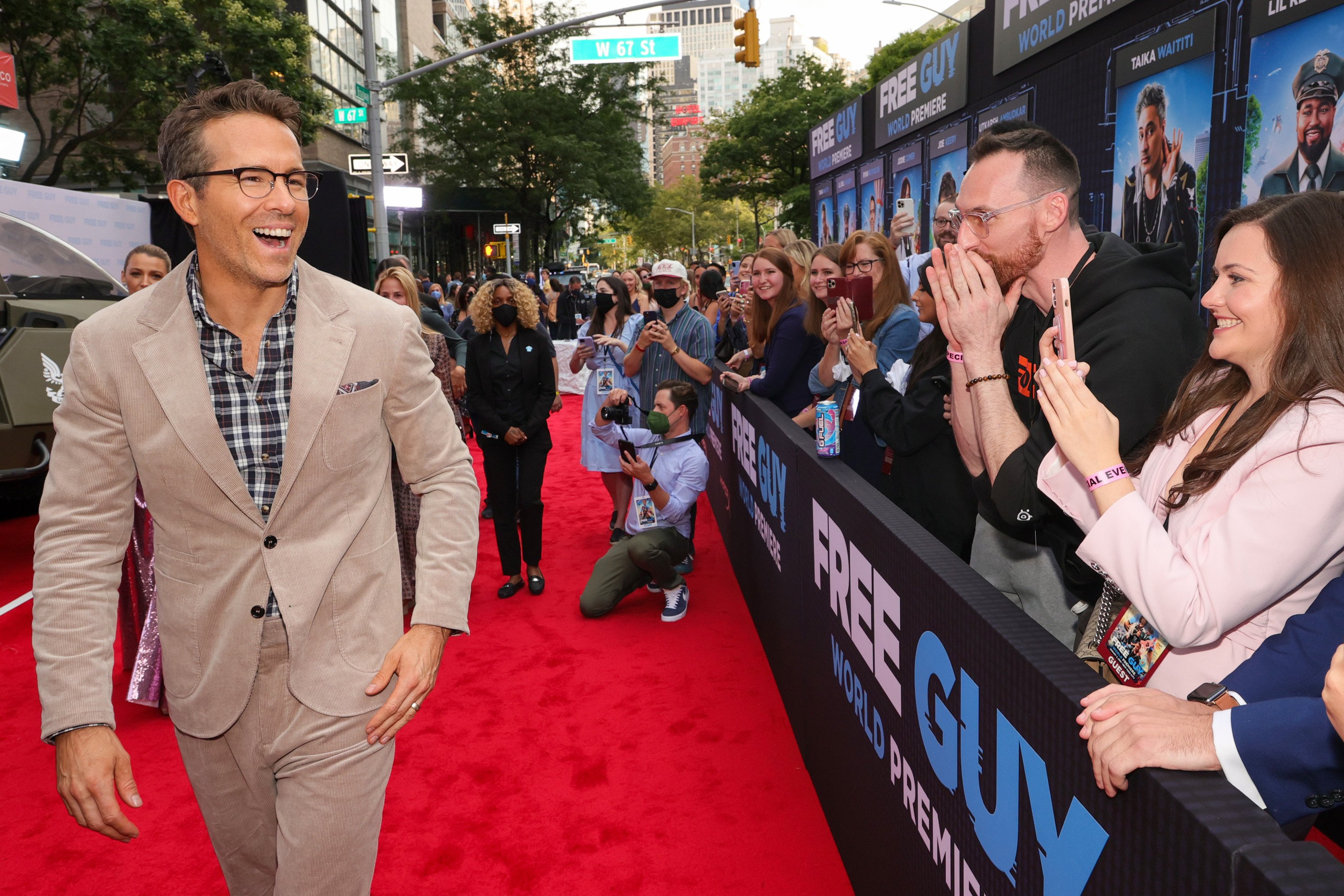 Ryan Reynolds smiling at fans at Free Guy premiere