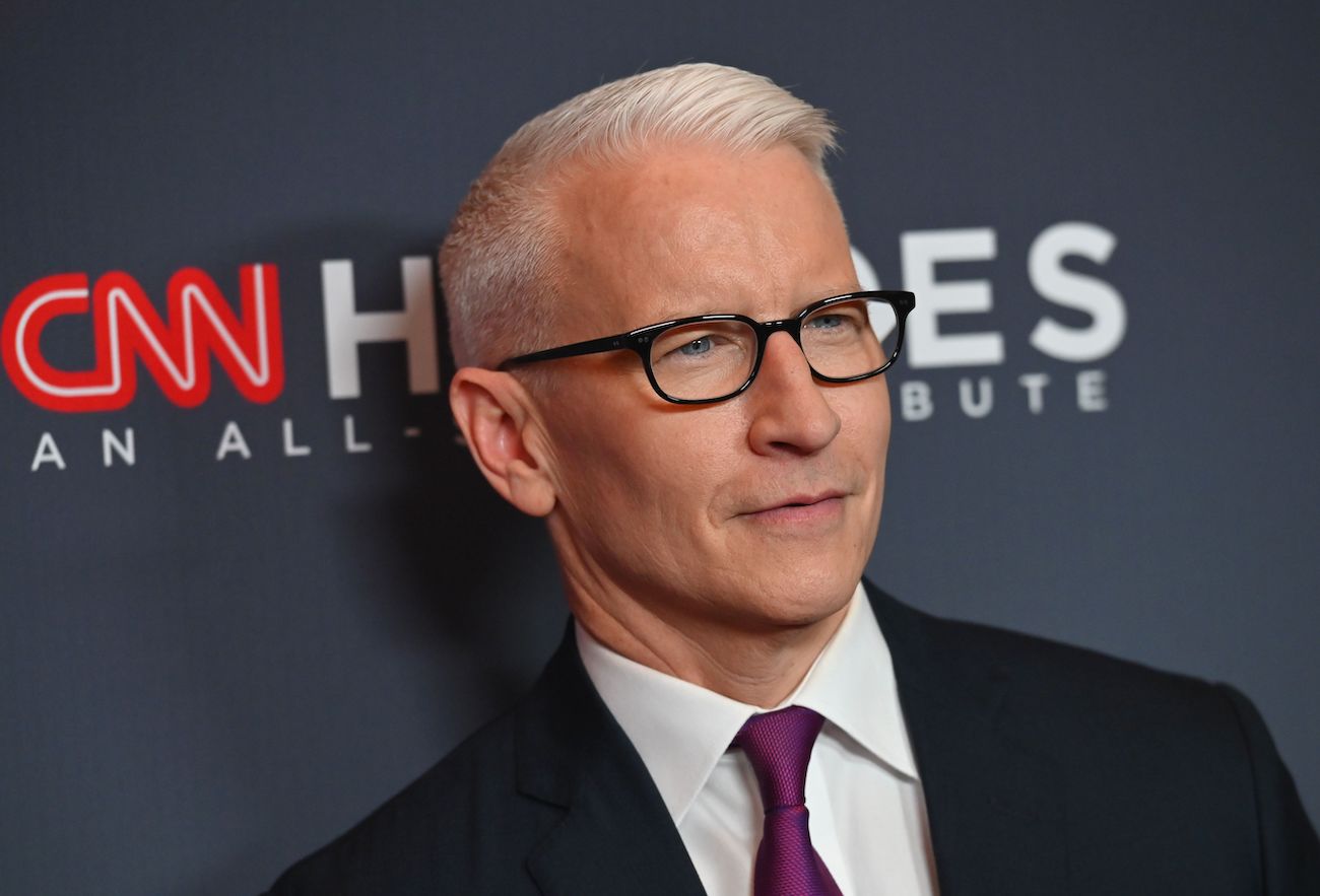 Anderson Cooper looking on in front of dark gray background