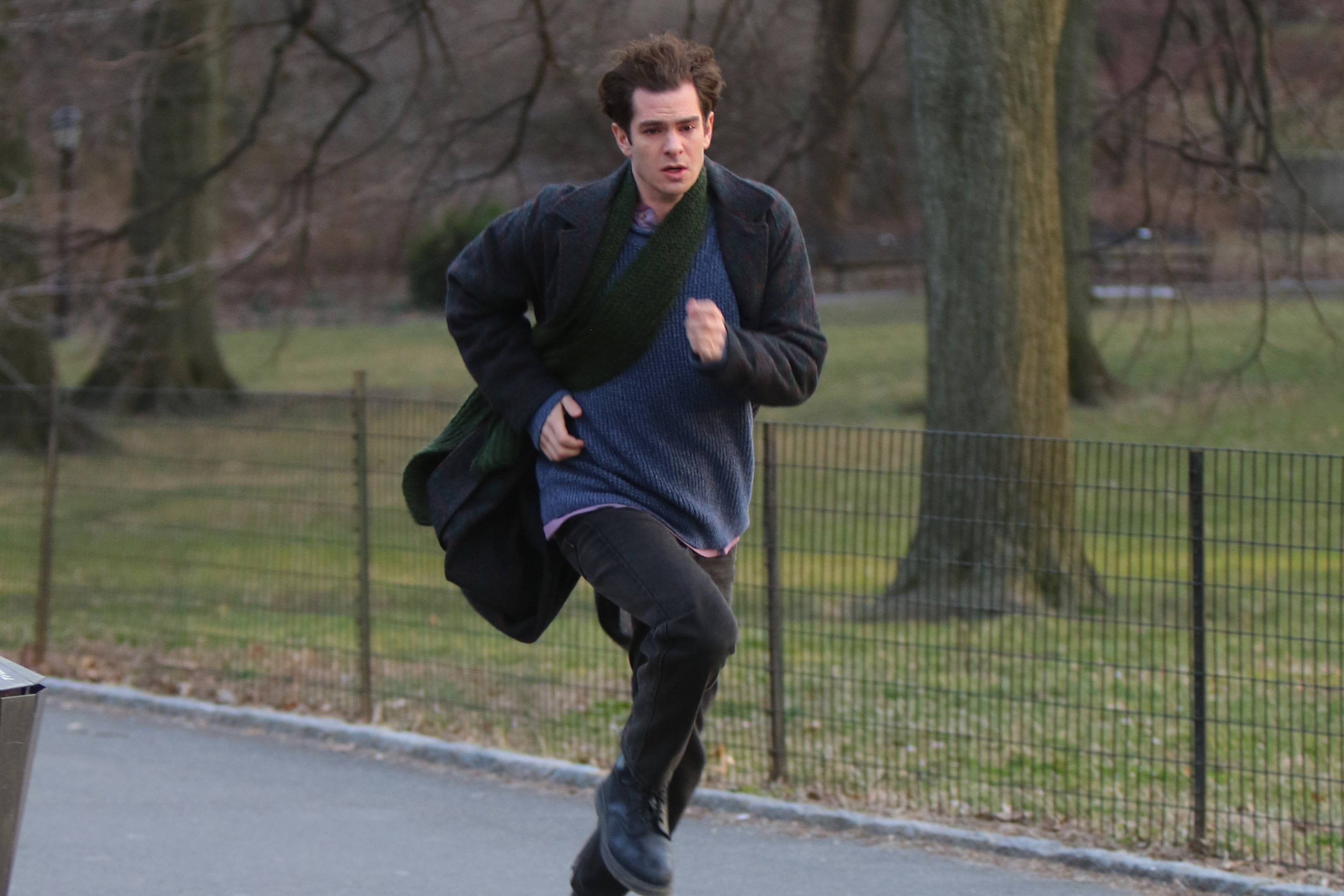 Andrew Garfield running in a black jacket and scarf with a blue t-shirt, while shooting for his movie 'Tick Tick... Boom!' in 2020.