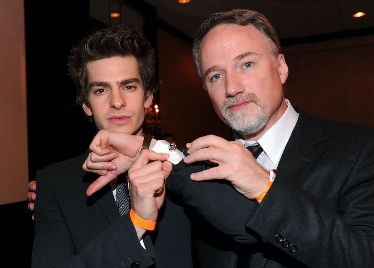 Andrew Garfield and David Fincher attend the Los Angeles Film Critics Association Awards in January 2011. They pose showing off Garfield's cufflinks at the event, both wearing black suits.Garfield and Fincher worked together on 'The Social Network.' And Garfield described Fincher's directing style as intense, but gratifying.