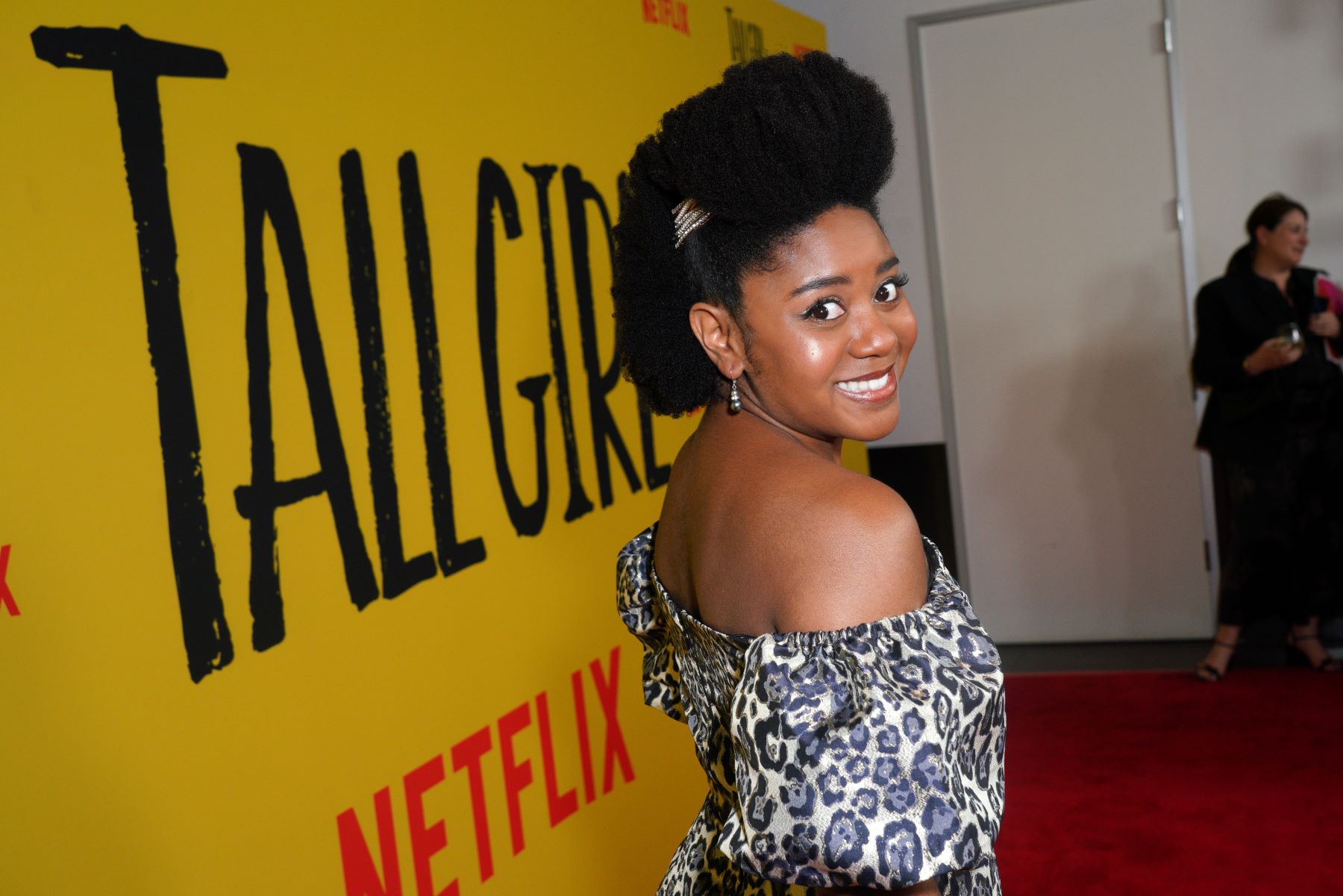 'Stargirl' Star Anjelika Washington, in a dress, smiles for cameras at a movie premiere.