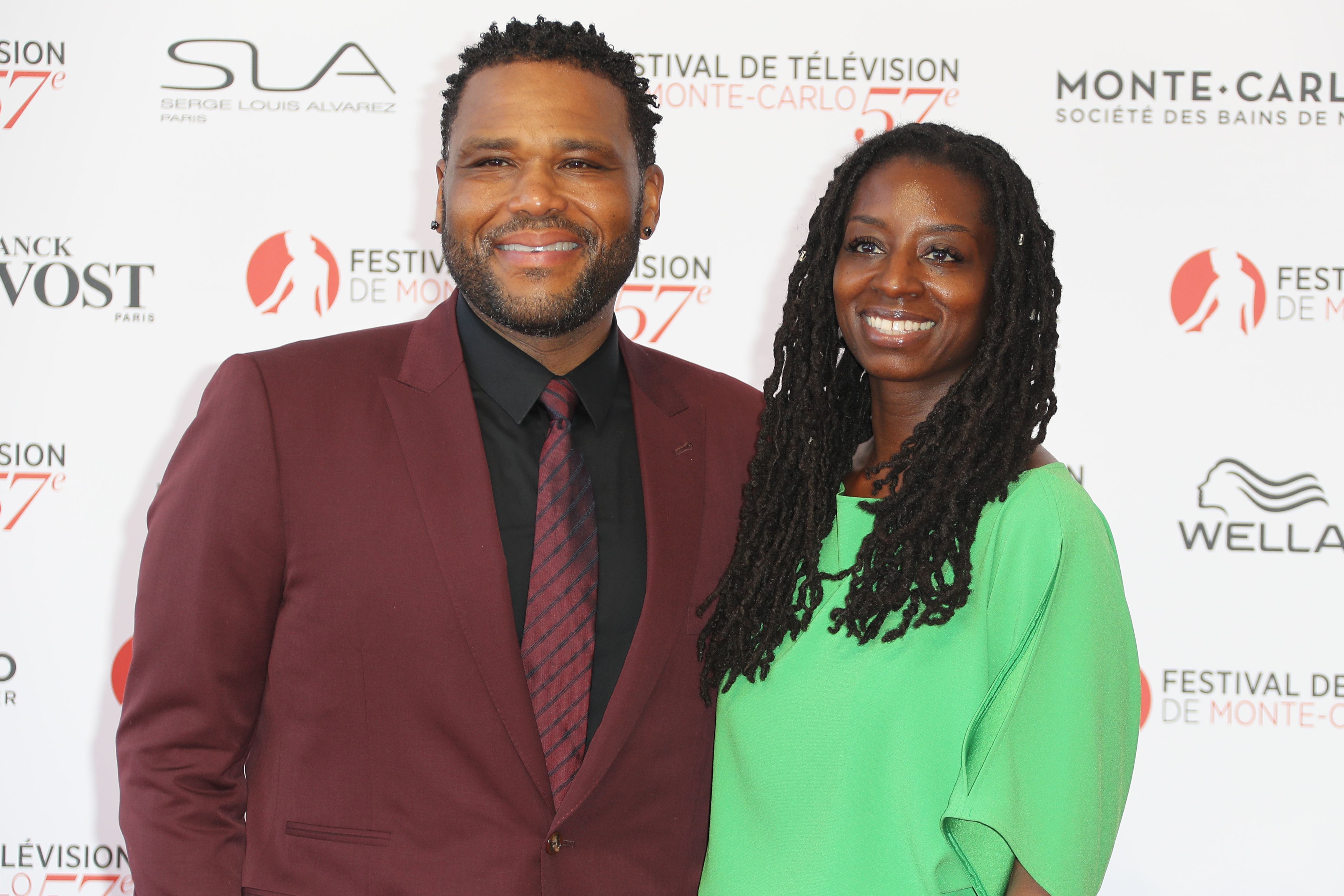 Anthony Anderson and wife Alvina Stewart smiling at the camera on the red carpet.