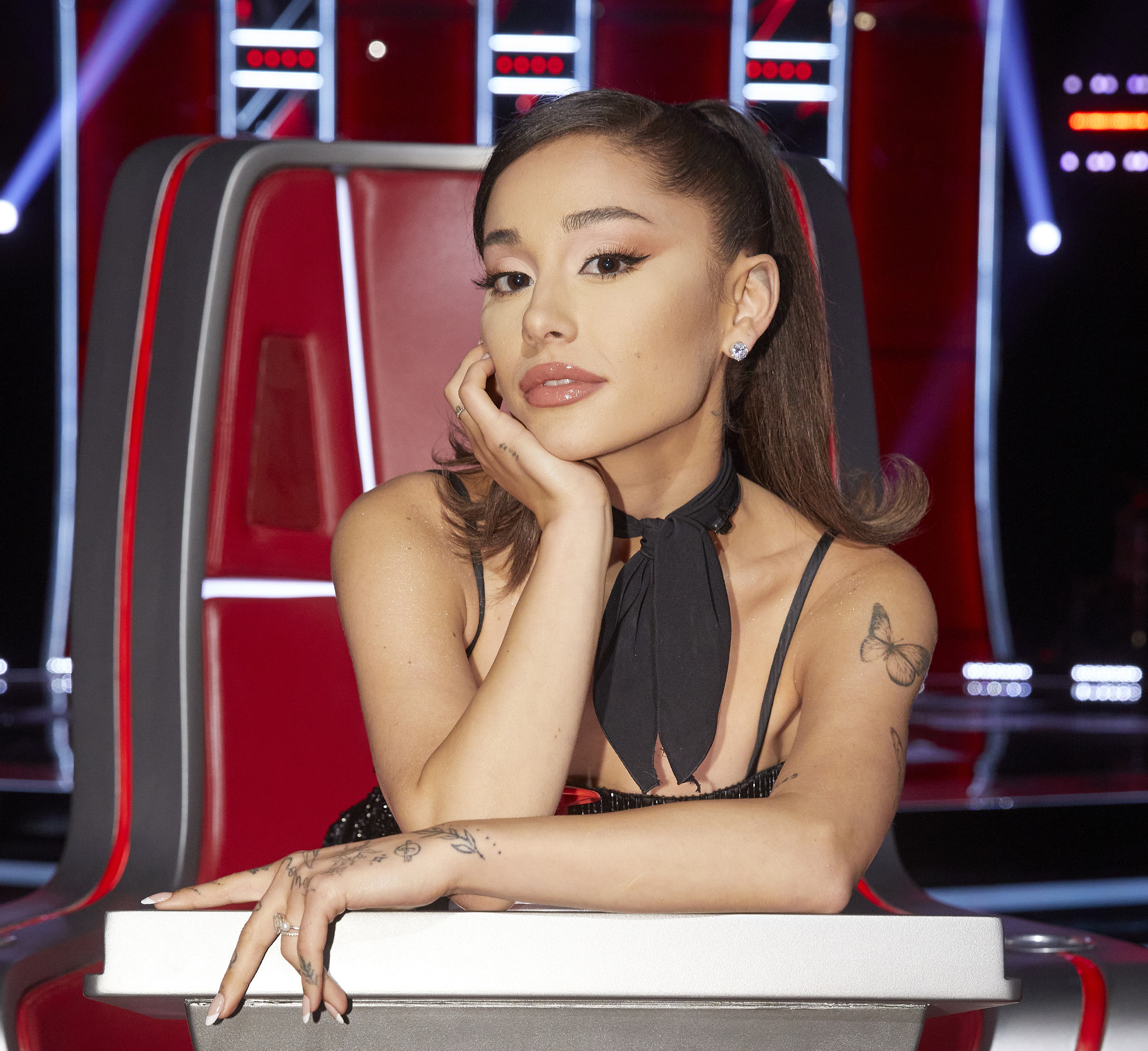 Ariana Grande posing in the judges' seat on NBC's 'The Voice' Season 21