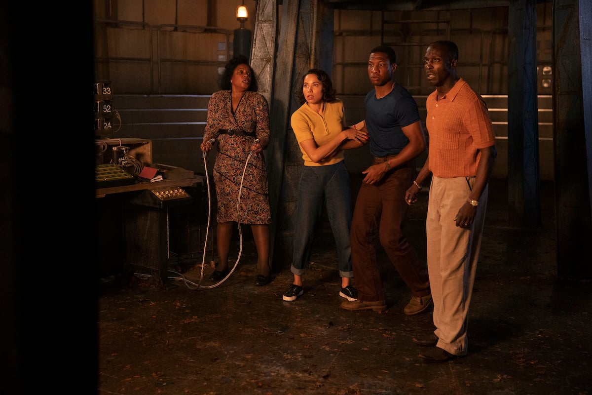 Aunjanue Ellis, Jurnee Smollett, Jonathan Majors, andMichael K. Williams standing together in 'Lovecraft Country' Season 1.