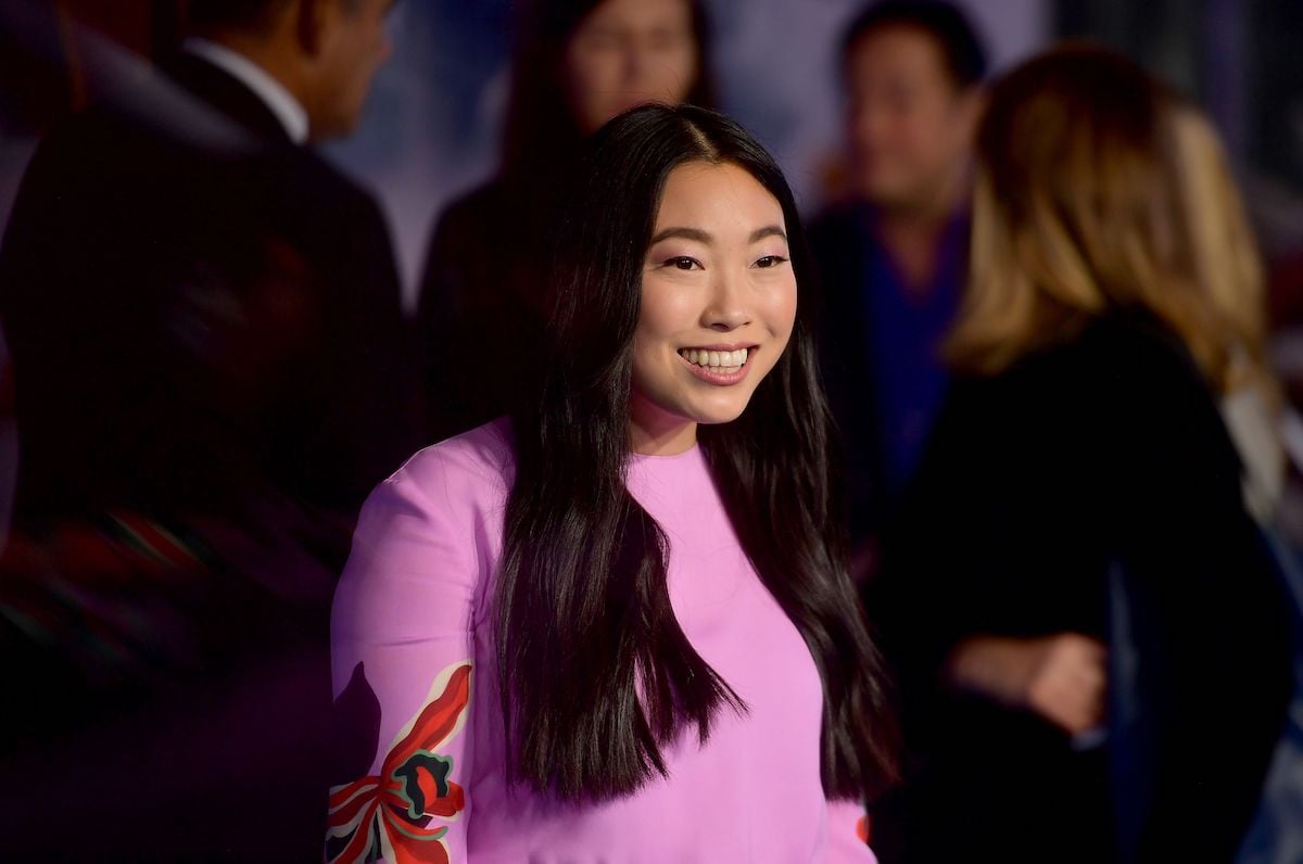 Awkwafina smiles in a pink dress as she poses for cameras at the 2019 premiere of 'Jumanji: The Next Level'
