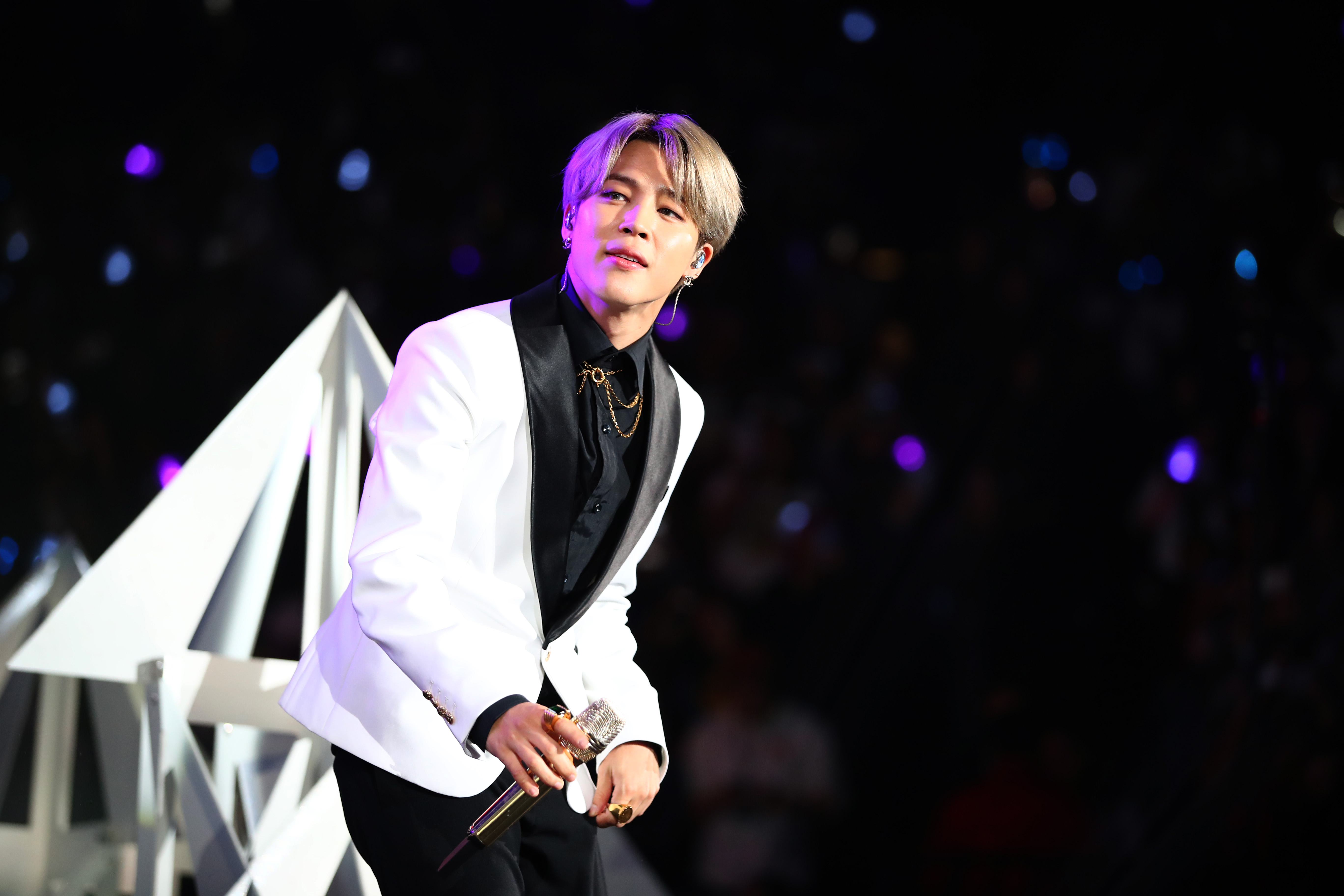 Jimin of BTS wears a white suit onstage at 102.7 KIIS FM's Jingle Ball 2019