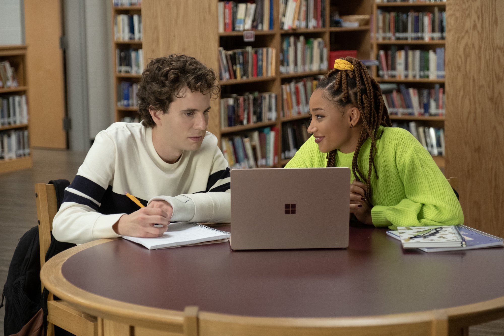 Ben Platt and Amandla Stenberg sit at a library table