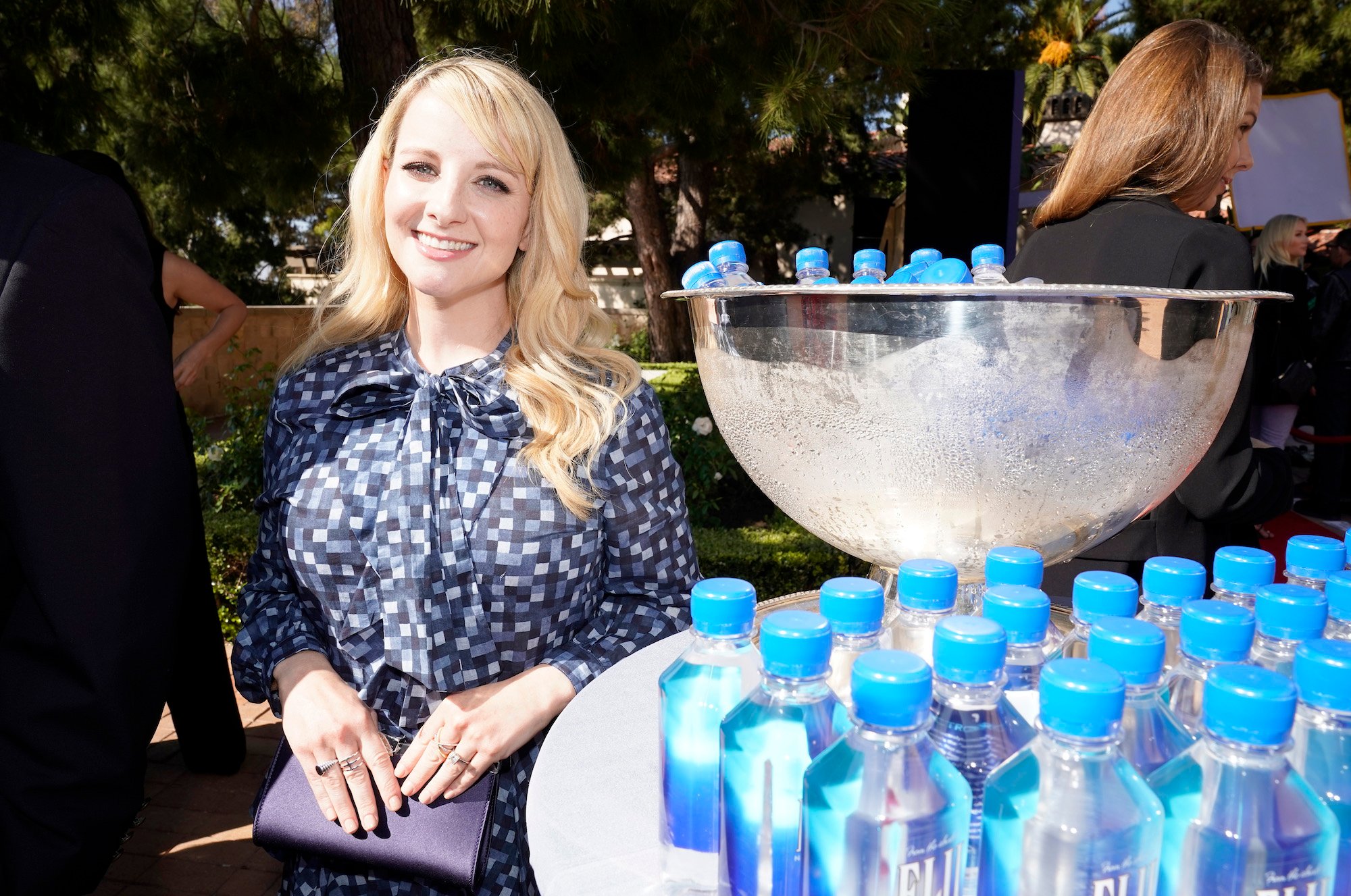 Big Bang Theory star Melissa Rauch stands by a Fiji water station