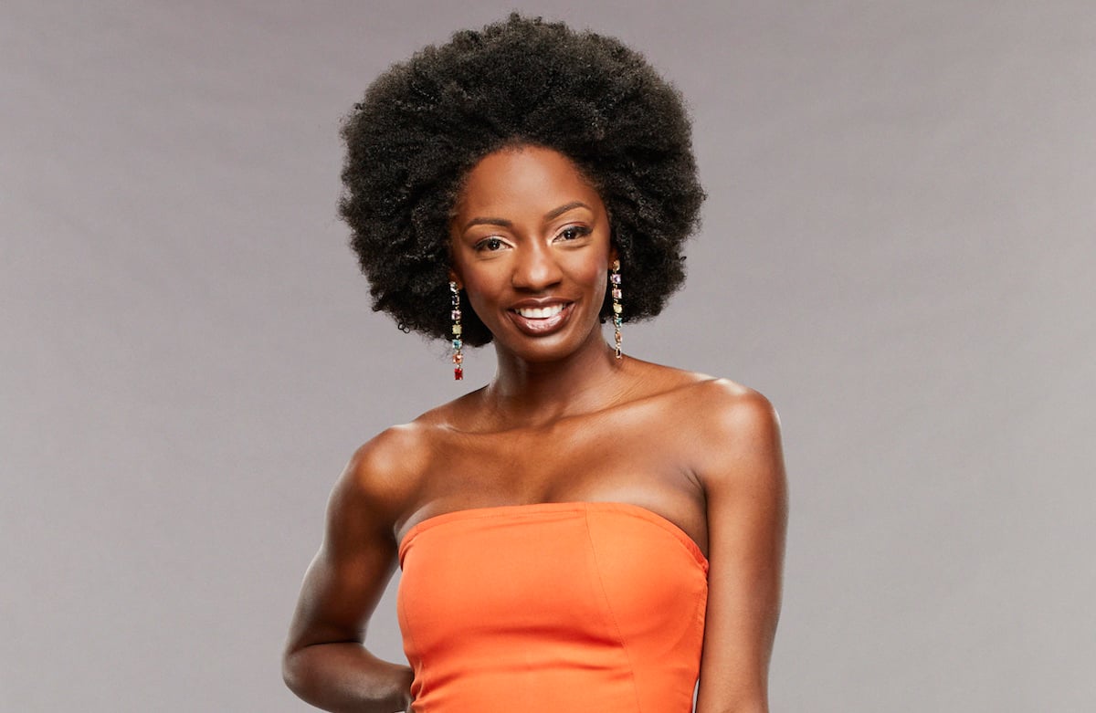 Azah Awasum of 'Big Brother' poses in an orange dress.