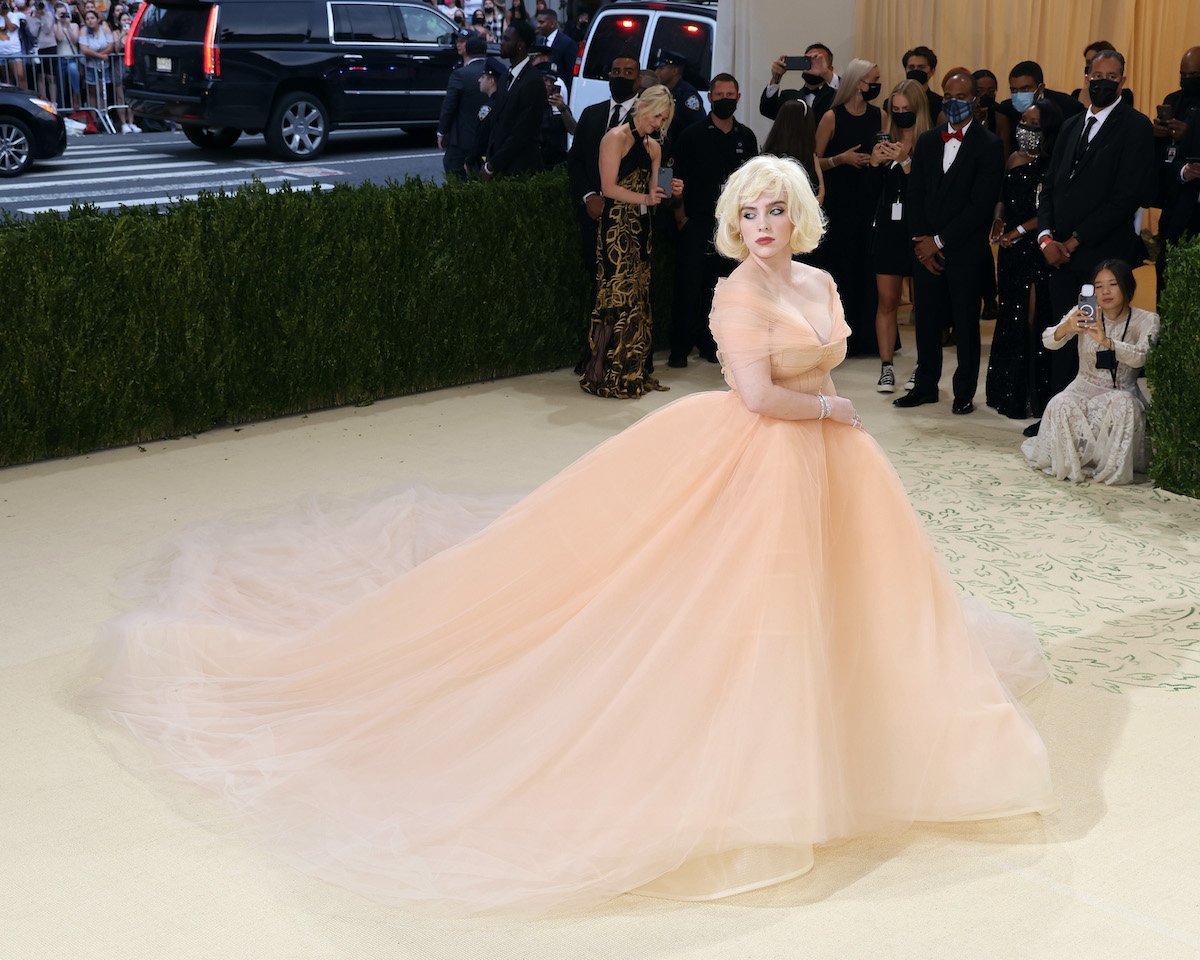 Billie Eilish arrives at the 2021 Met Gala wearing a nude tulle gown with a 15-foot train.