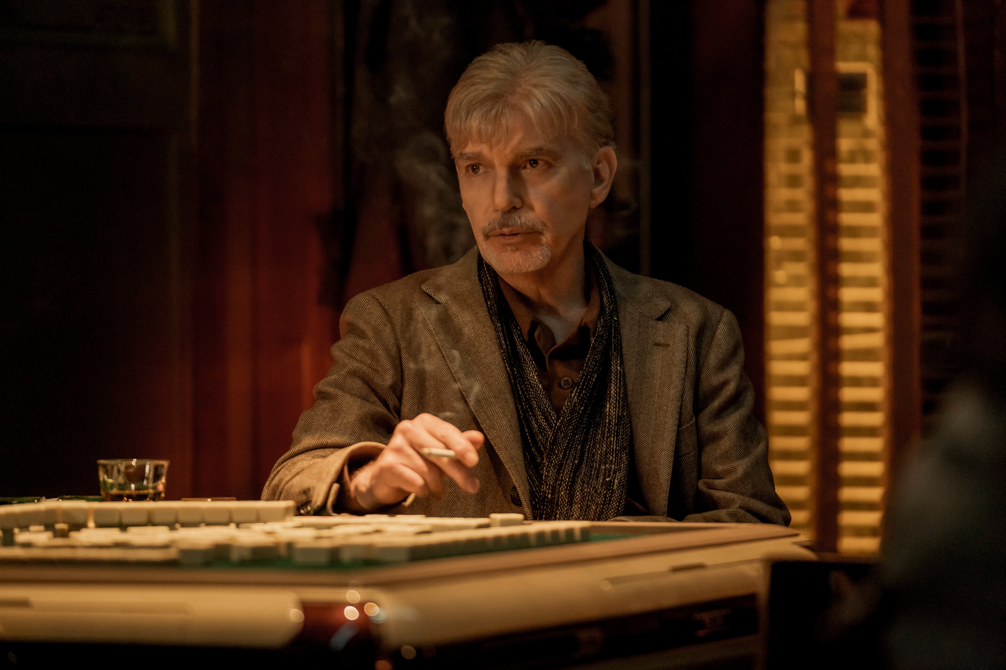 Billy McBride (Billy Bob Thornton) smoking a cigarette at a bar in 'Goliath' Season 4