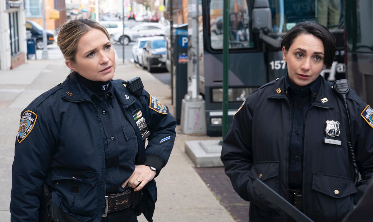 Vanessa Ray as Officer Eddie Janko and Lauren Patten as Officer Rachel Witten stand in their cop uniforms on the street on 'Blue Bloods'