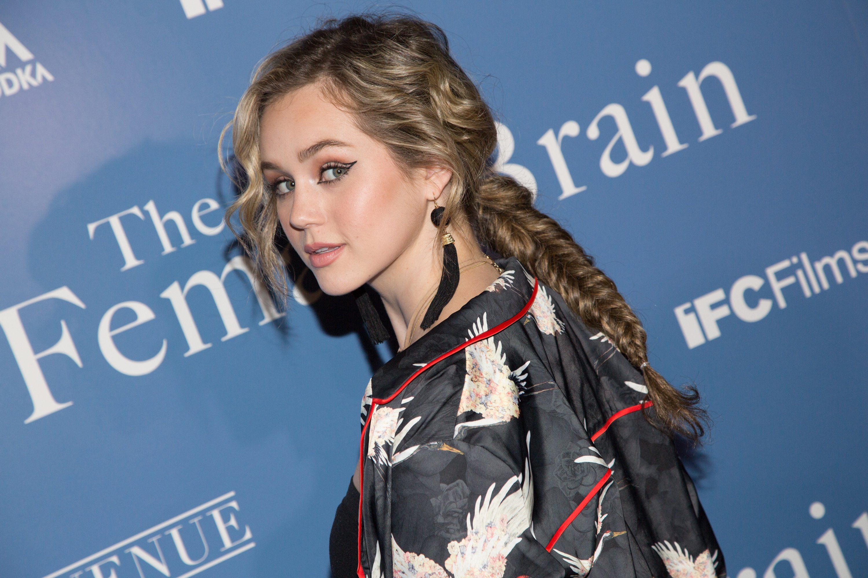 'Stargirl' Season 2 actor Brec Bassinger wears a braid and long earrings.