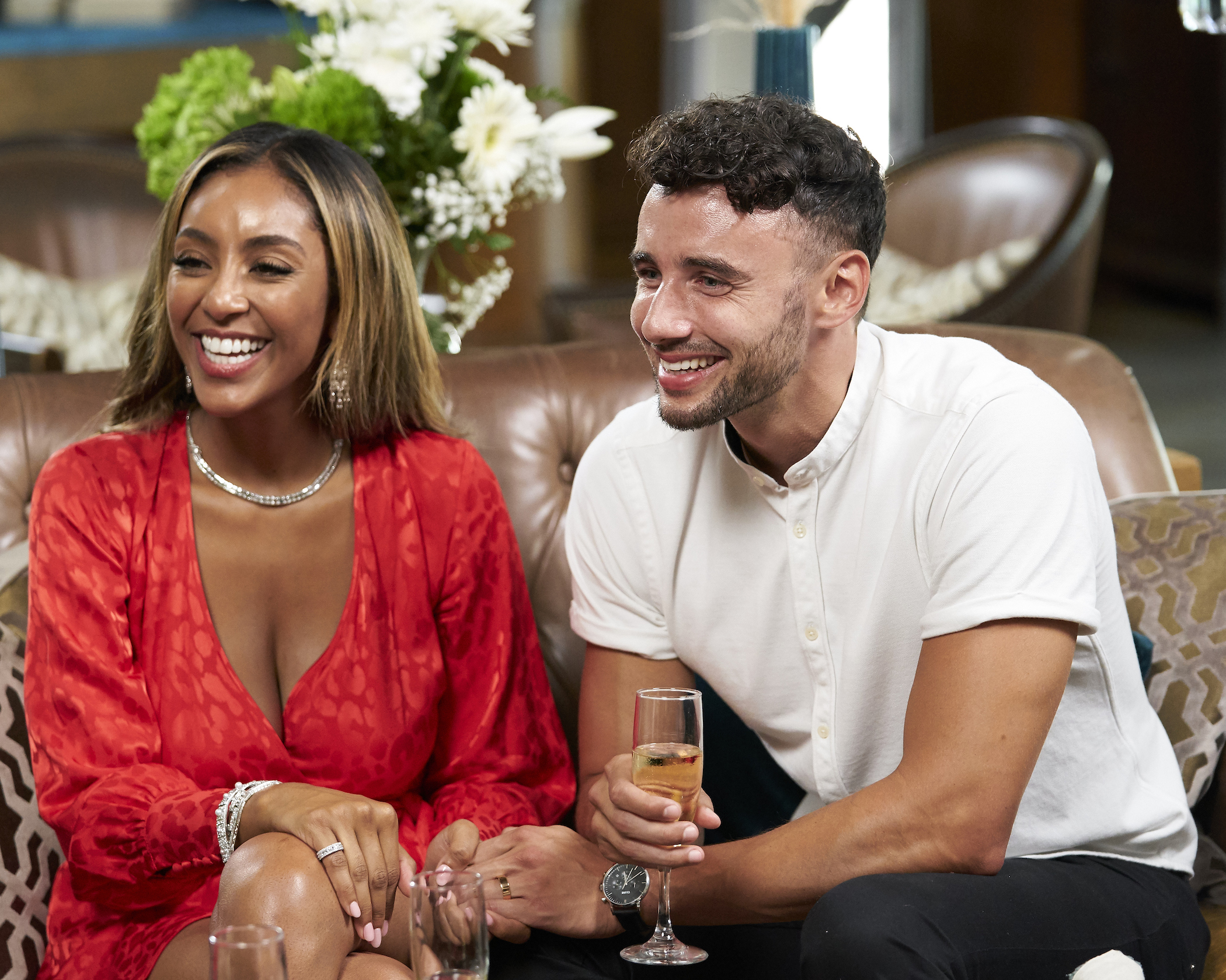 Tayshia Adams and Brendan Morais sitting next to each other and smiling on 'The Bachelorette.' Brendan Morais is on 'Bachelor in Paradise' Season 7