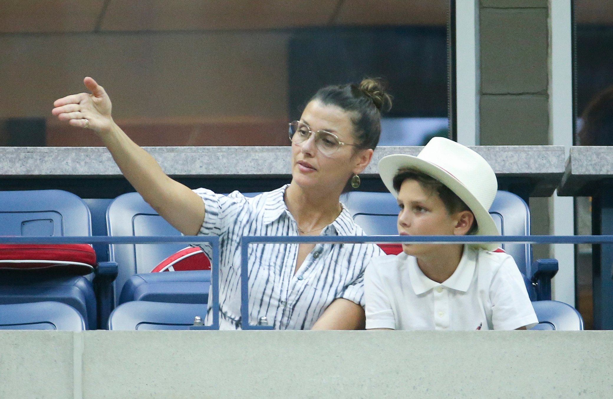 Bridget Moynahan sitting in the stands at the U.S. Open with her and Tom Brady's son John