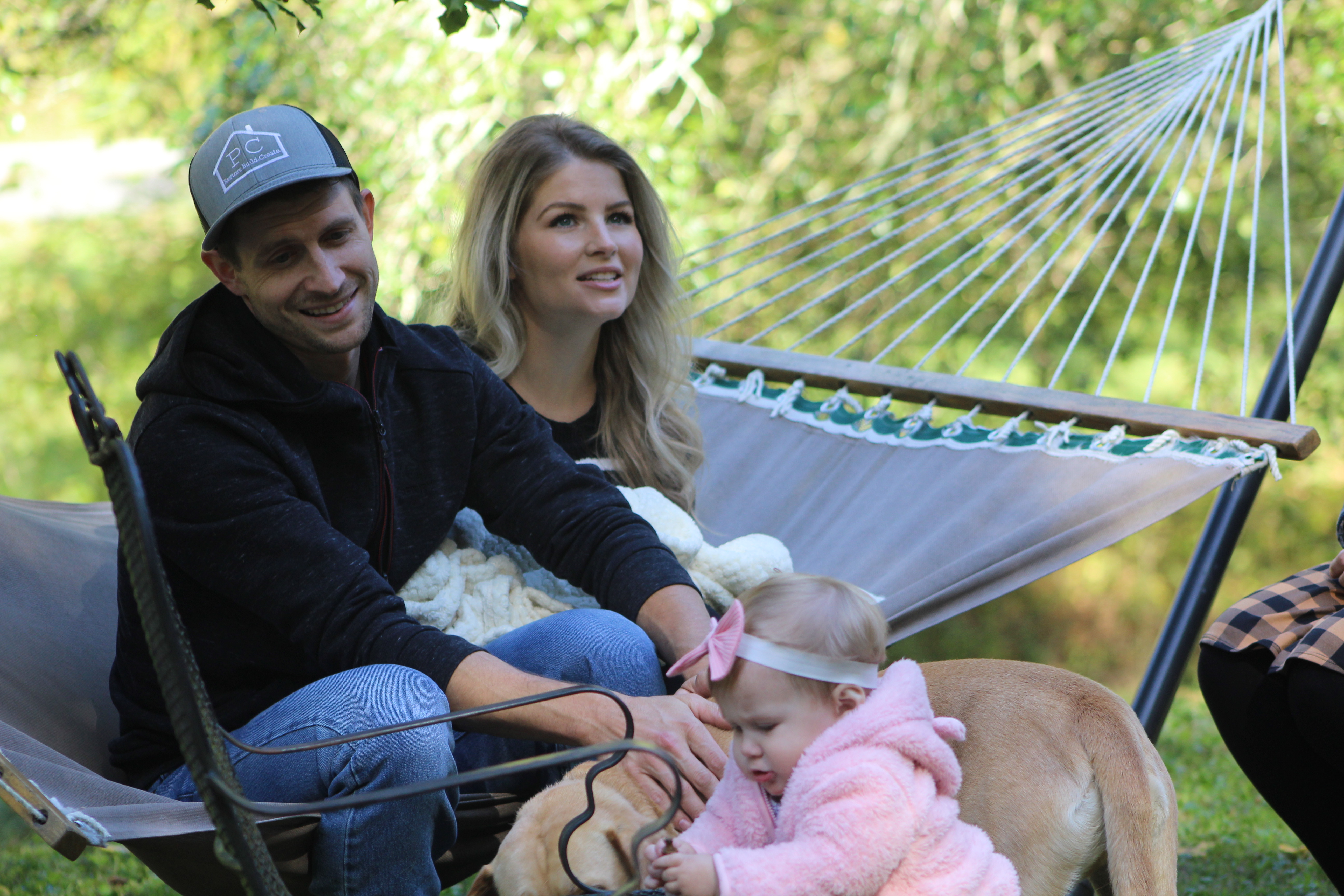 Couple sitting on hammock with baby in scene from 'Bringing Up Bates' Season 10