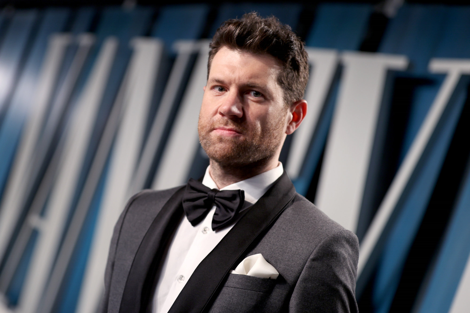 'Bros' actor and co-writer Billy Eichner at the 2020 Vanity Fair Oscar Party wearing a gray and black tuxedo