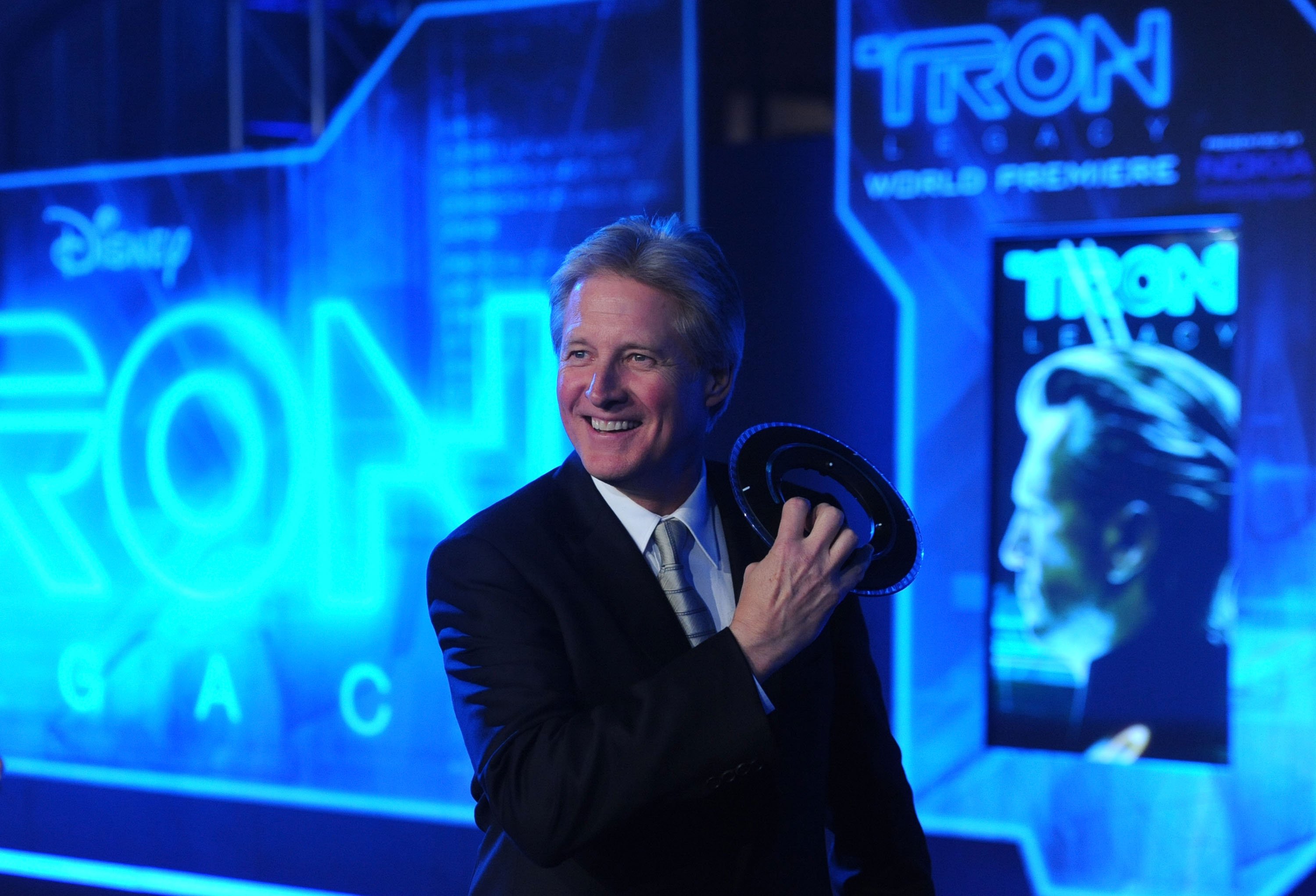 Bruce Boxleitner smiling in a black suit while attending the 'Tron' premiere.