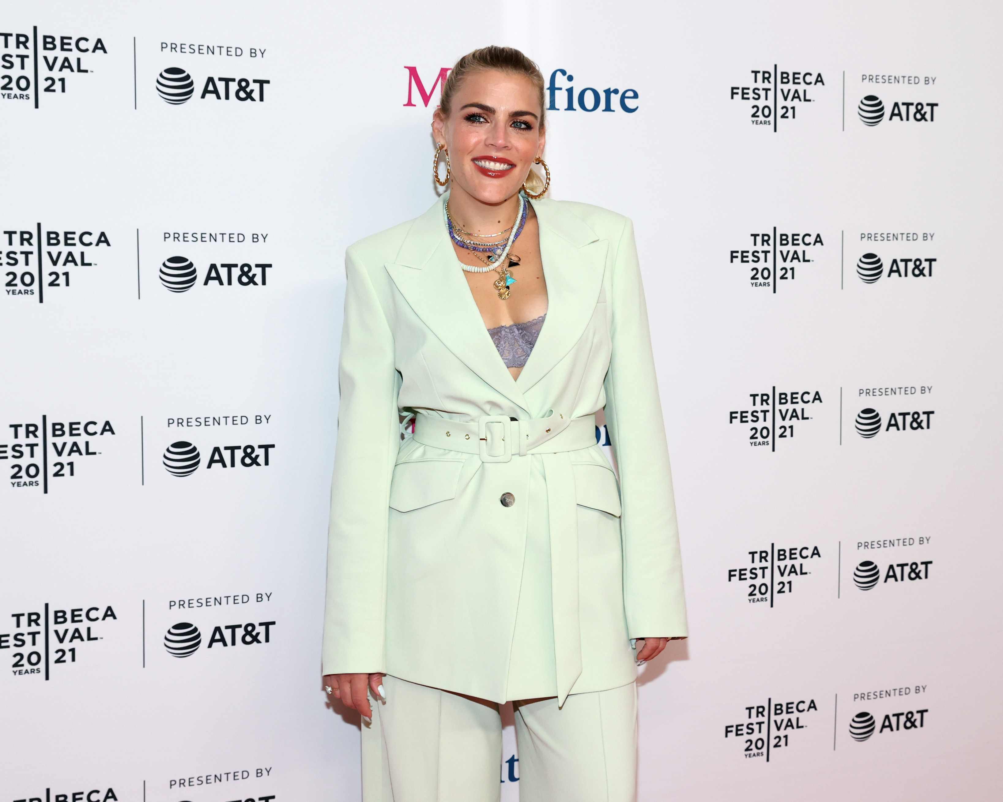 Busy Philipps wears a cream colored suit.