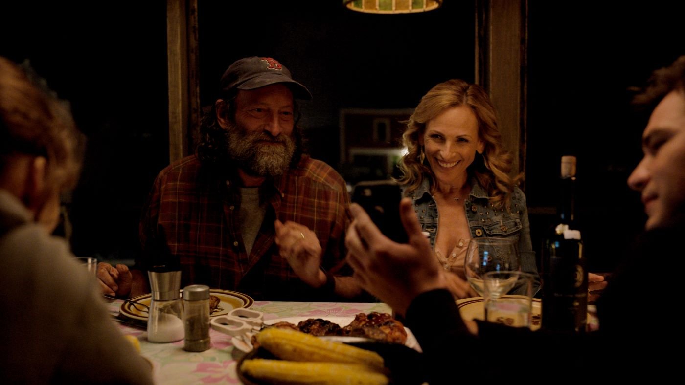 A scene from 'CODA' with the family sitting around the table at dinner.