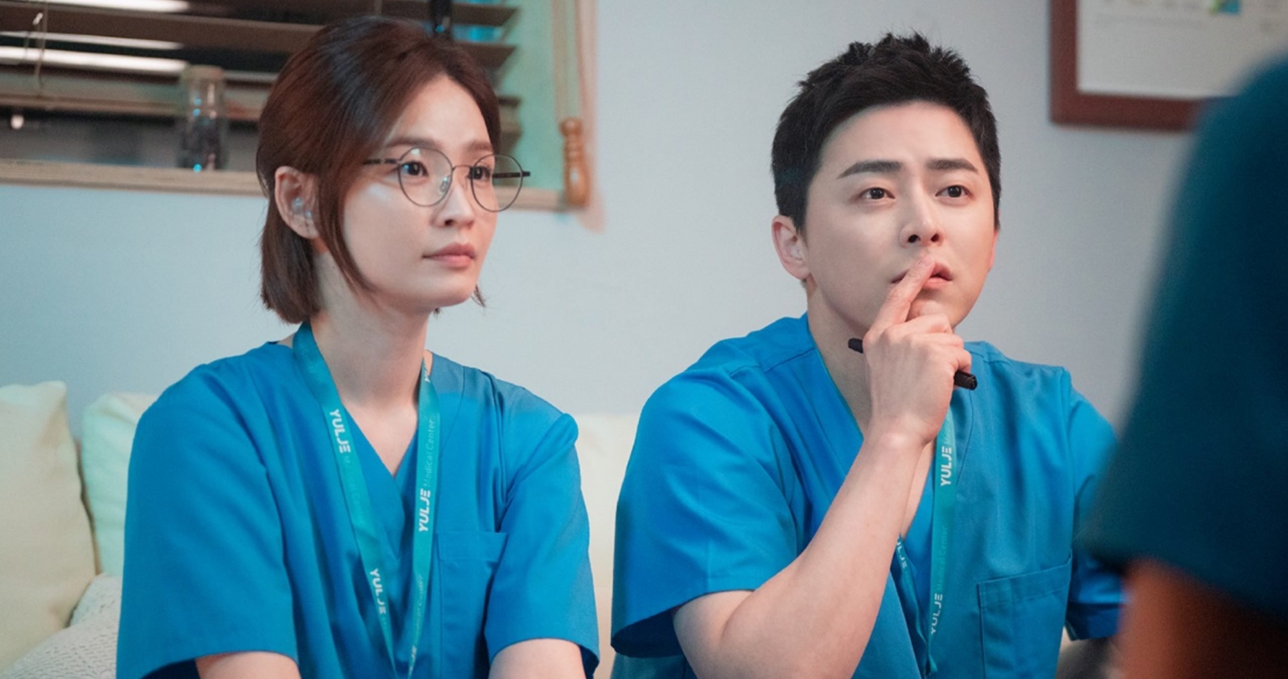 Characters Song-Hwa and Ik-Joon in 'Hospital Playlist' wearing blue doctor scrubs