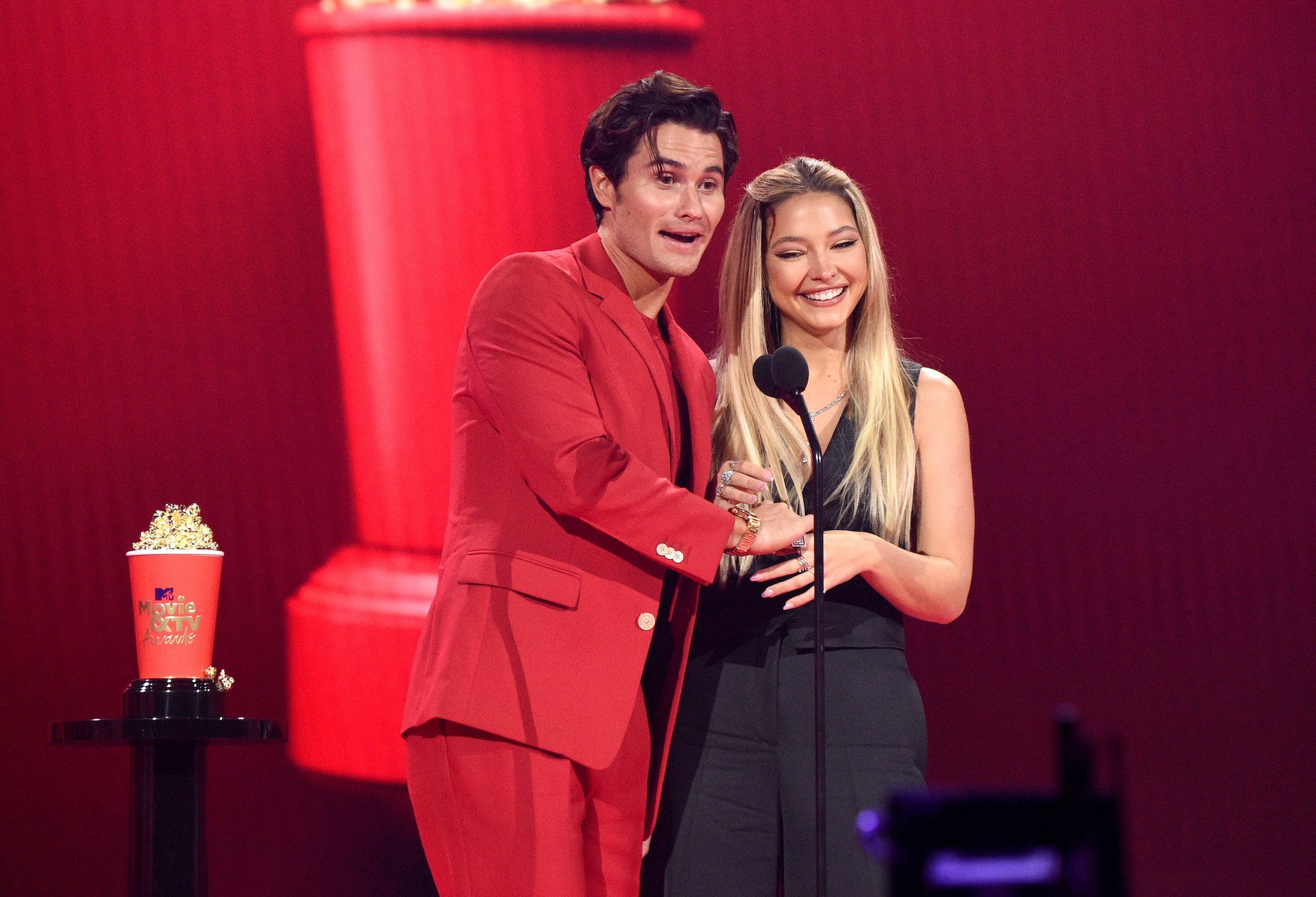Chase Stokes and Madelyn Cline accepting an award at the 2021 MTV Movie & TV Awards