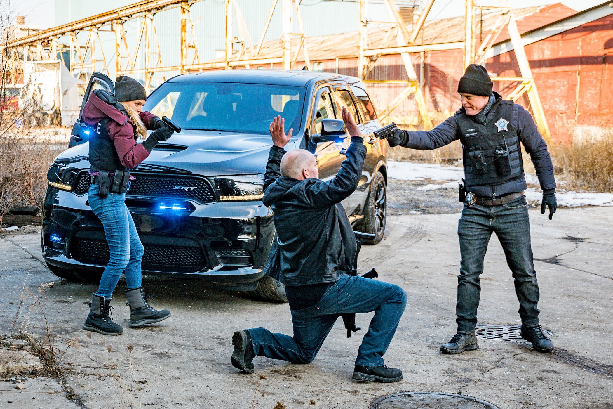 Hailey Upton and Hank Voight from 'Chicago P.D.' Season 9 with their guns pointed at a suspect