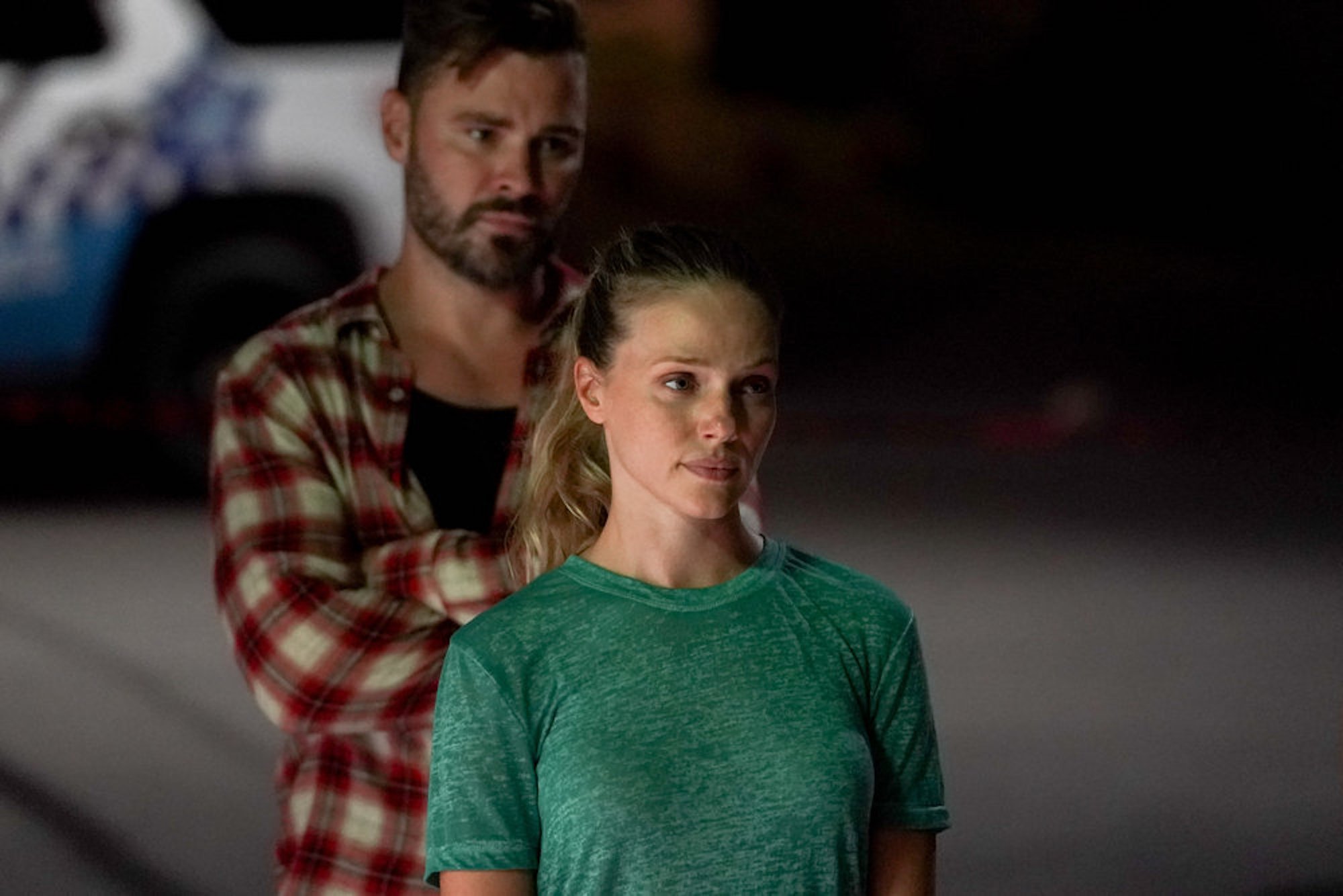 Adam Ruzek standing behind Hailey Upton in 'Chicago P.D.' Season 9. Some fans suspect Hailey's leaving 'Chicago P.D.' Season 9 after Jay Halstead learned she killed Roy.