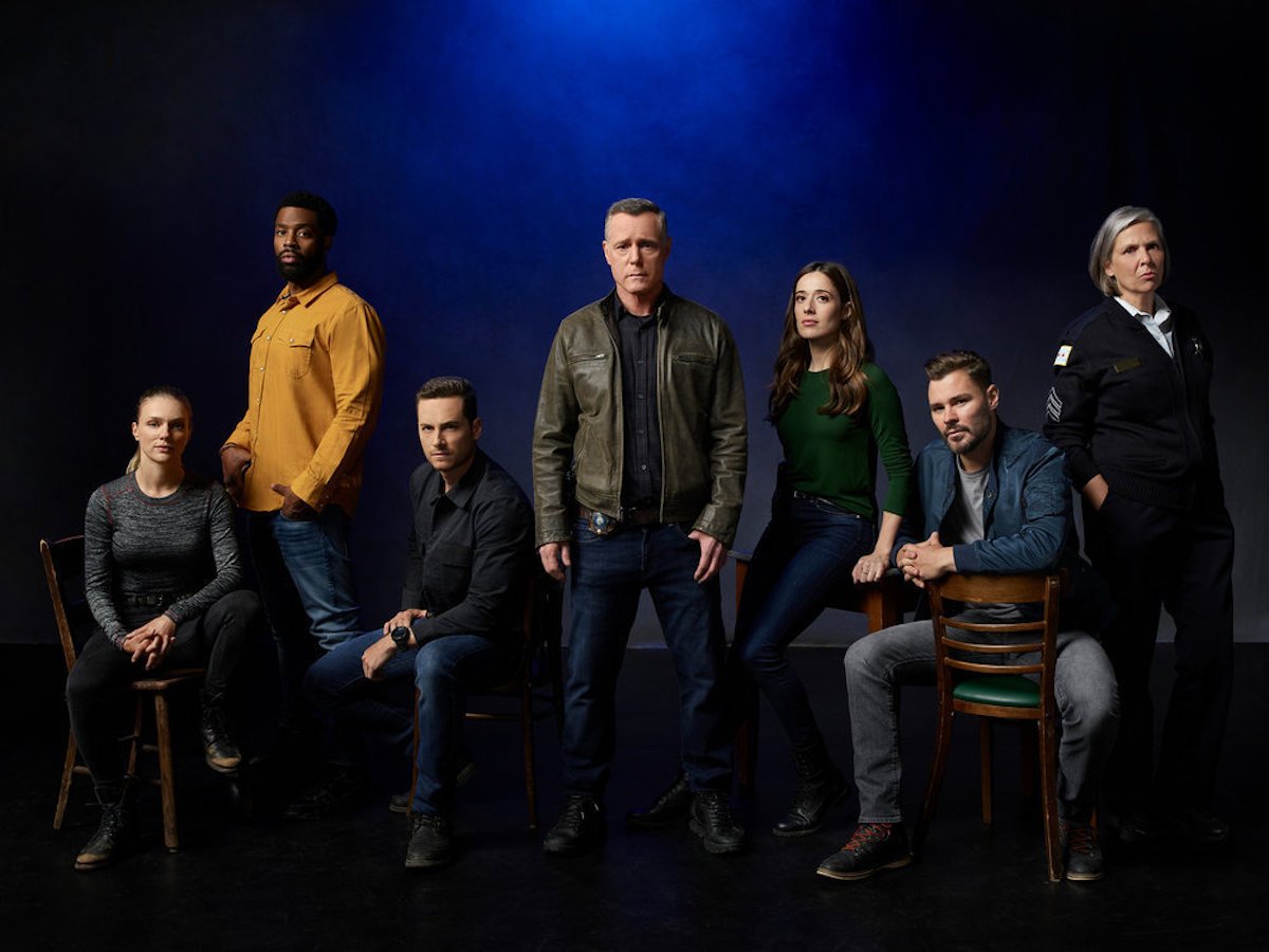 The 'Chicago P.D.' Season 9 cast looking serious against a dark blue background. 'Chicago P.D.' is part of many One Chicago crossover events.