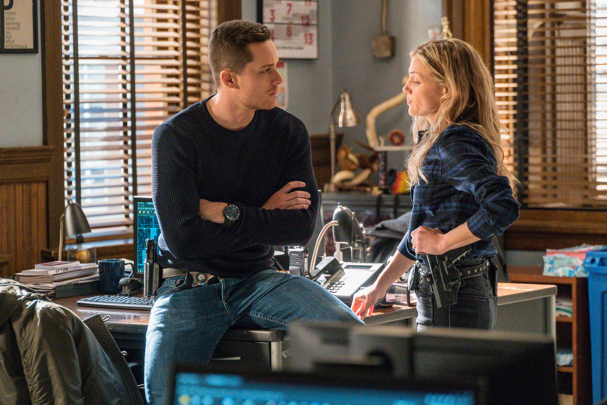 Jay Halstead and Hailey Upton from 'Chicago P.D.' Season 9 standing together and talking. 'Chicago P.D.' Season 9 spoilers note they get engaged