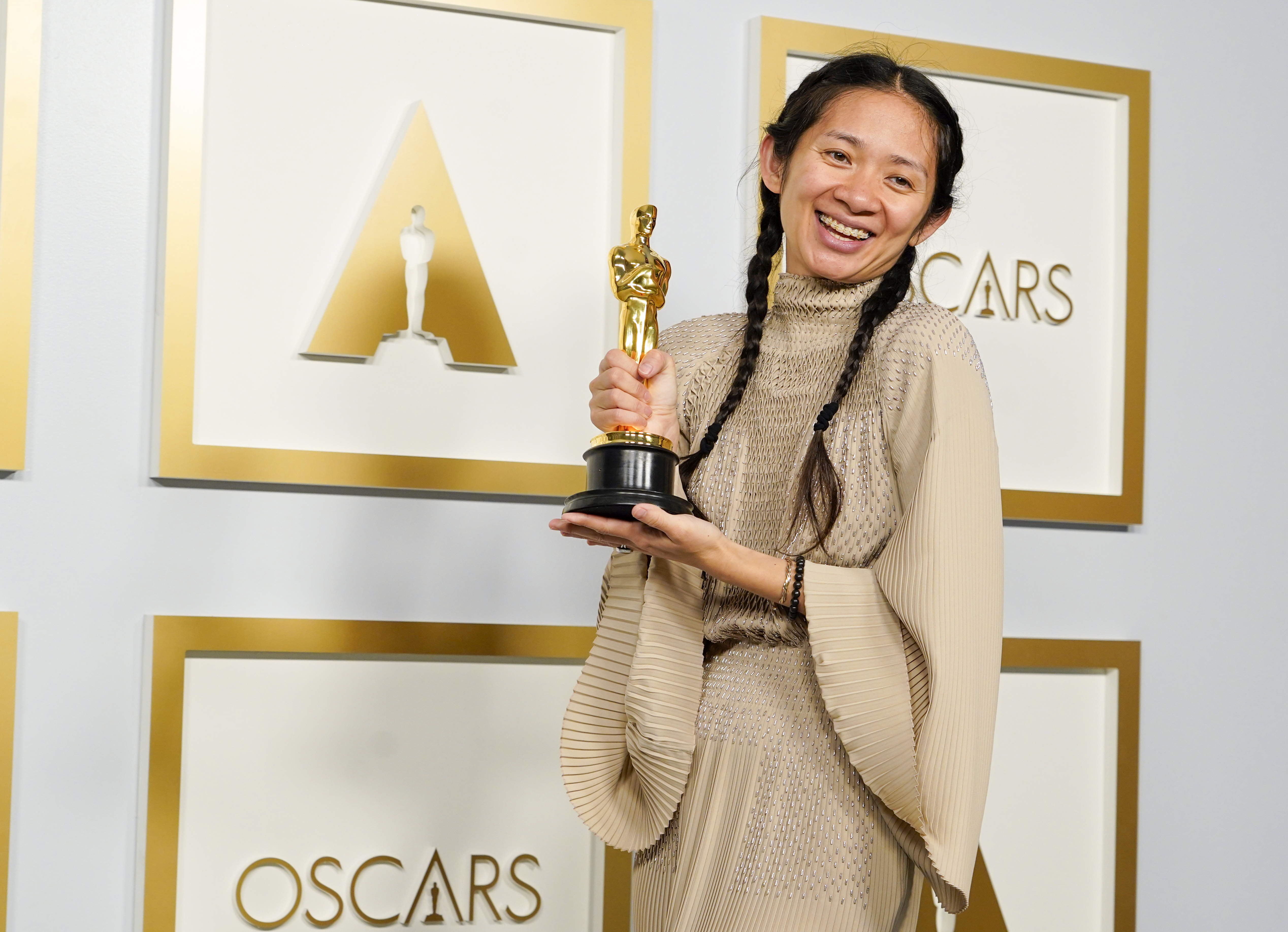 Chloé Zhao, 'Eternals' director, poses with her Oscar award.