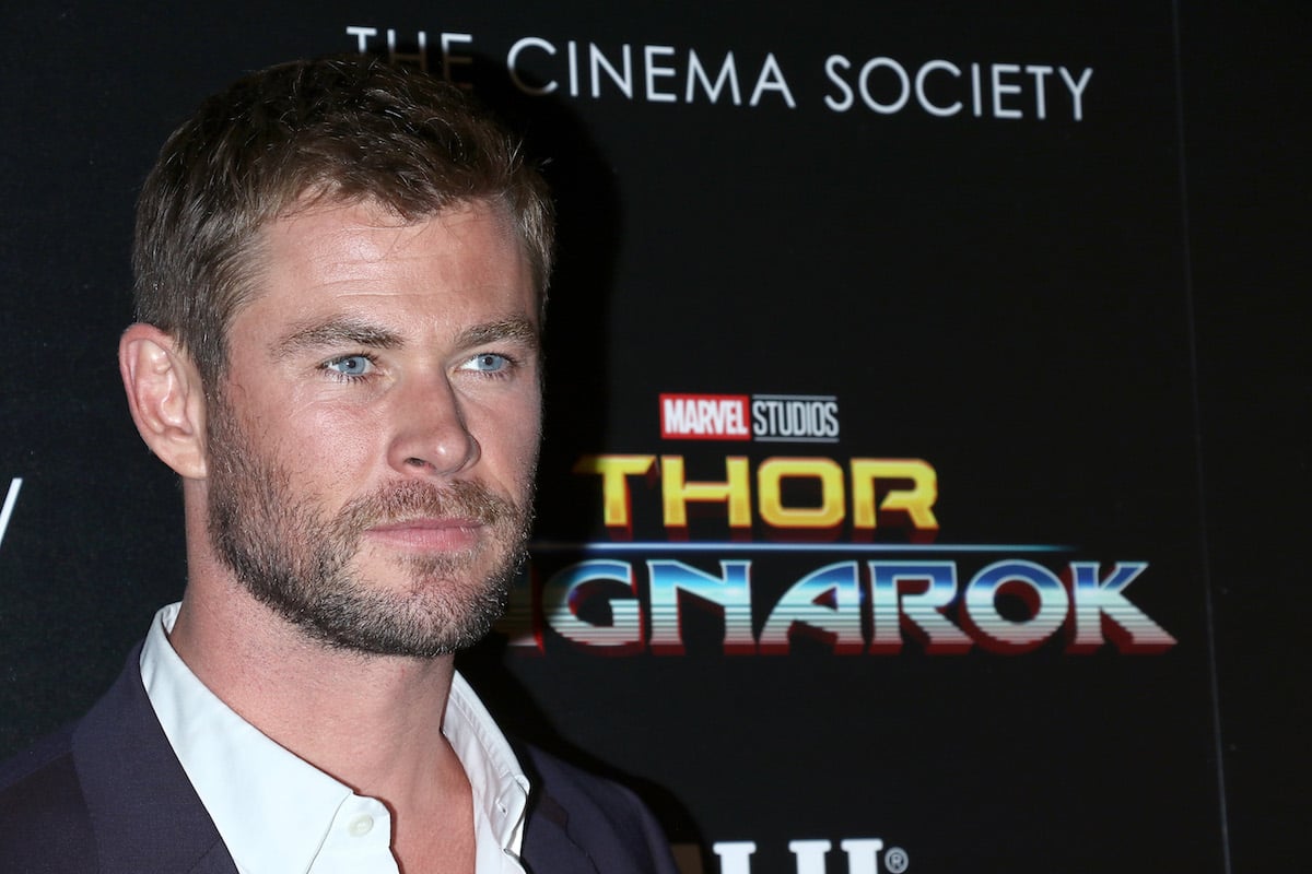 Chris Hemsworth in front of a 'Thor' banner