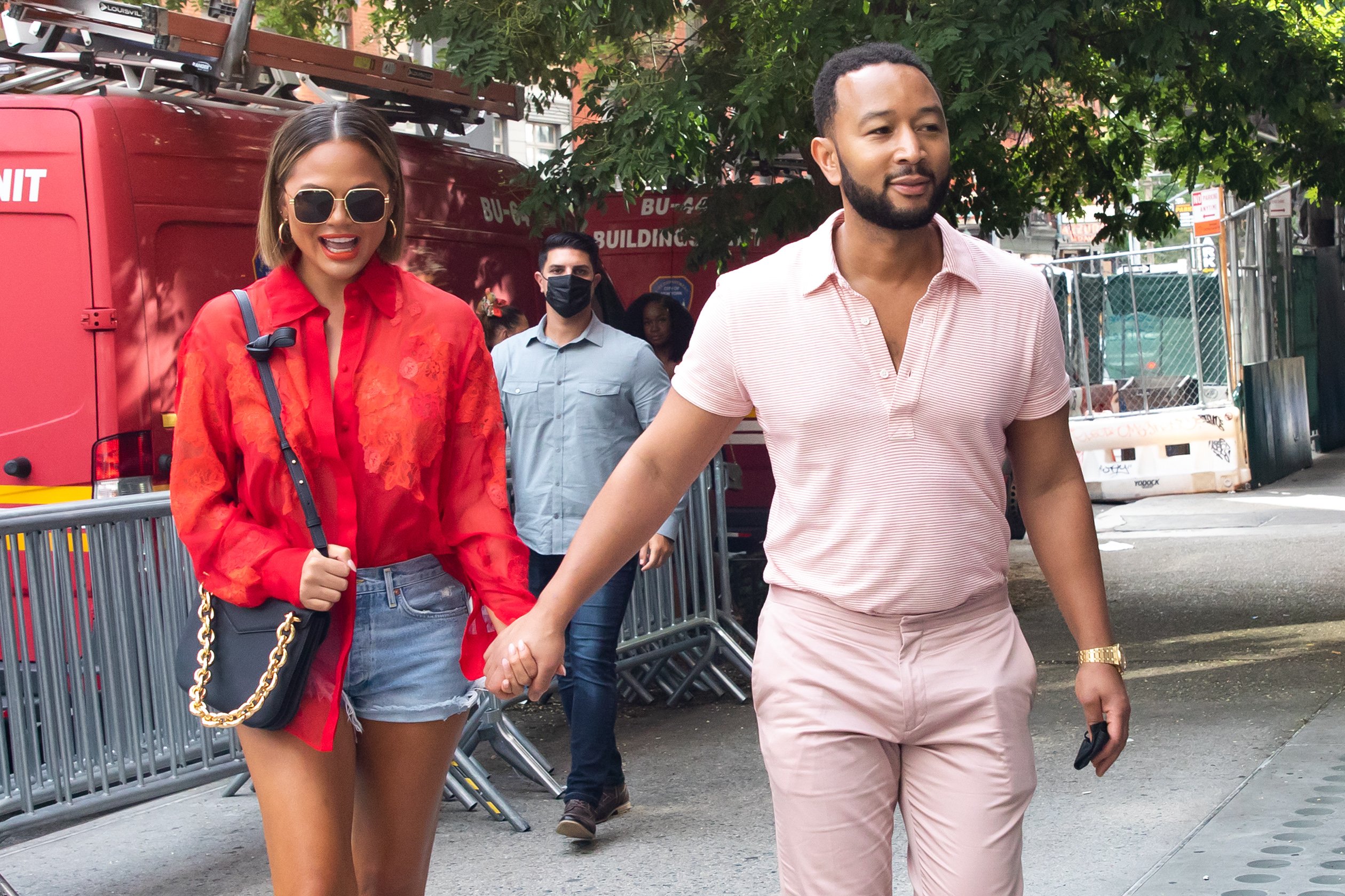 Chrissy Teigen and John Legend holding hands as they walk around New York City.