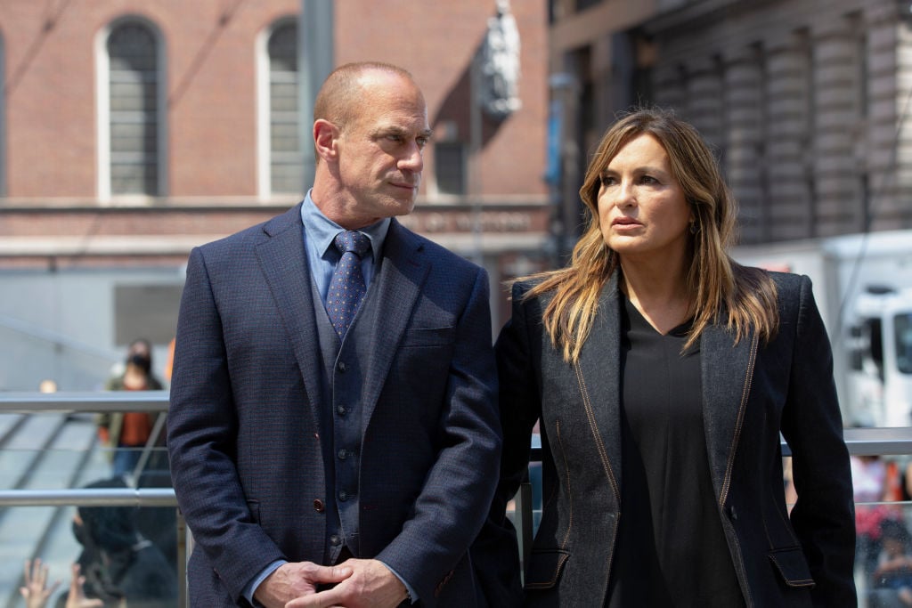 Christopher Meloni as Detective Elliot Stabler and Mariska Hargitay as Captain Olivia Benson stand side-by-side in dark suits in a scene from 'Law & Order: Organized Crime.'