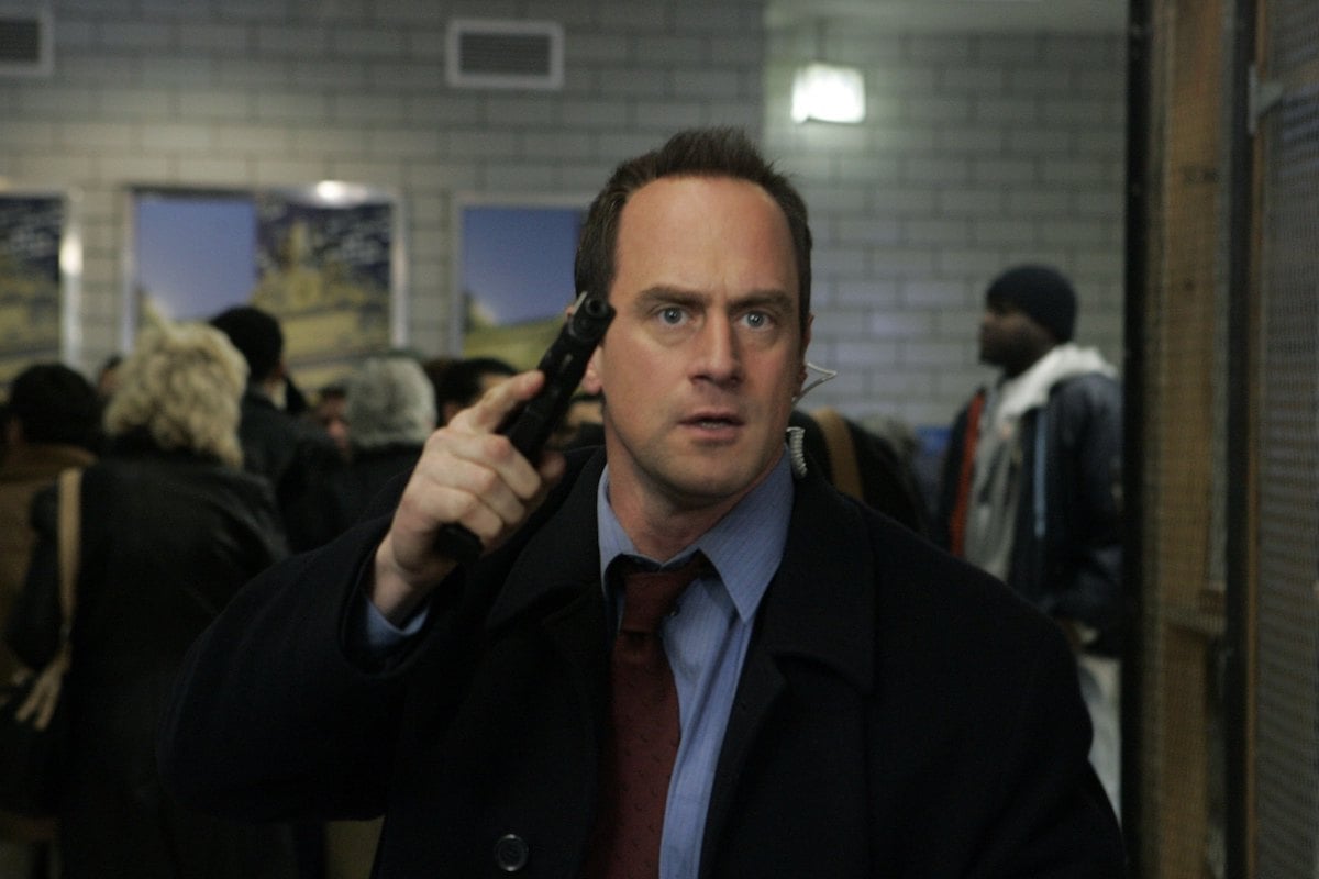 Christopher Meloni as Detective Elliot Stabler holding a weapon in 'Law & Order: SVU'