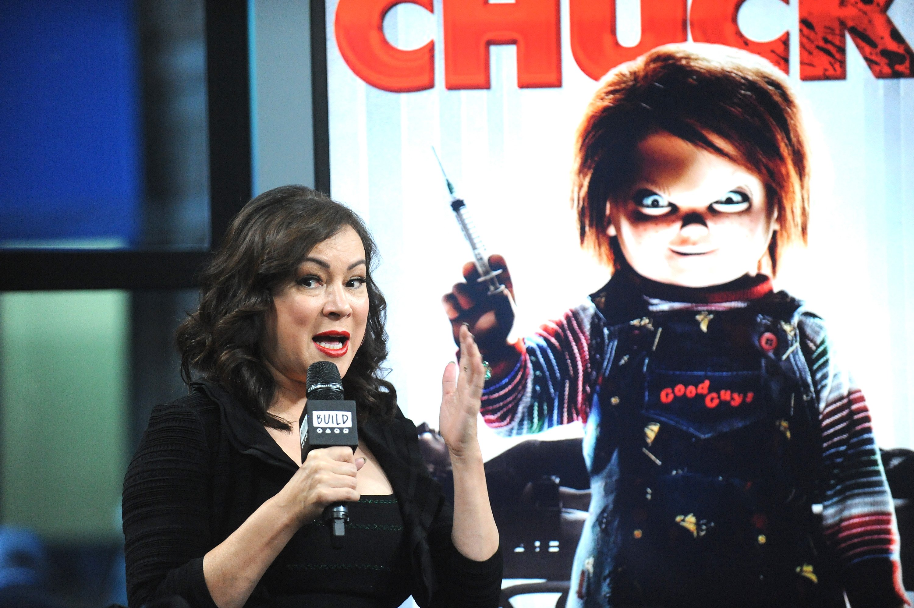 Chucky star Jennifer Tilly speaks into a microphone