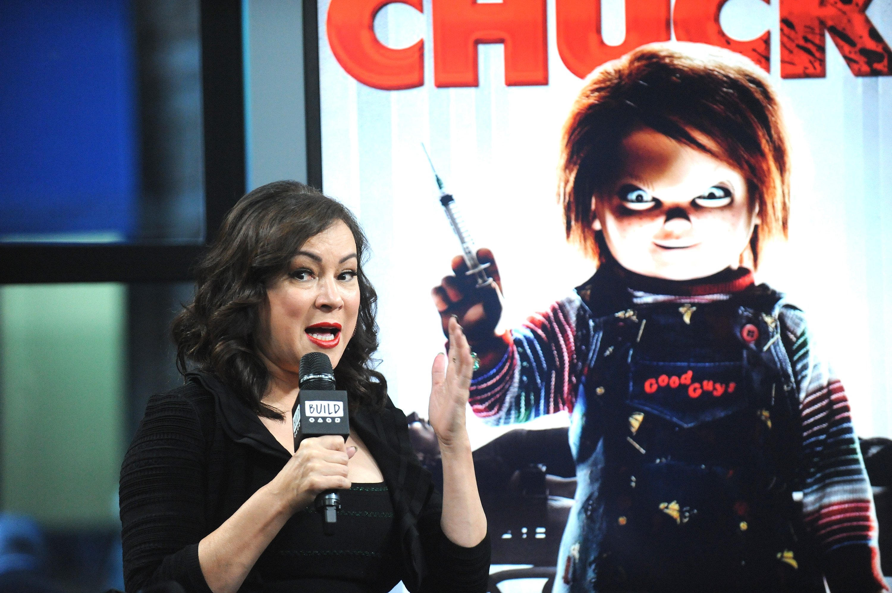 Chucky star Jennifer Tilly speaks into a microphone