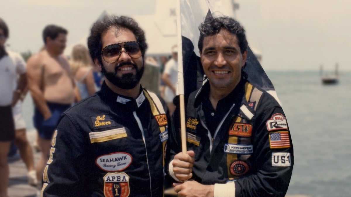 Salvator Magluta and Augusto ‘Willie’ Falcon smile and hold a flag in 'Cocaine Cowboys: The Kings of Miami